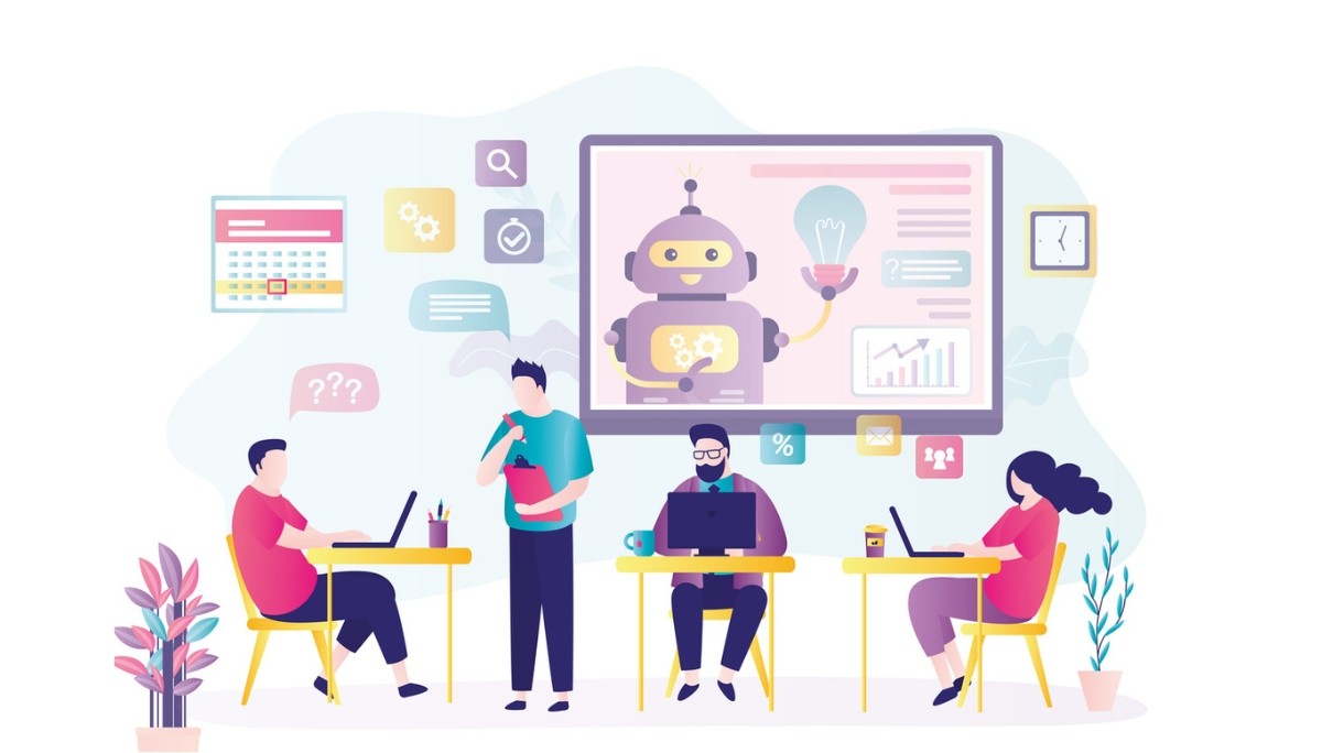 Illustration of a modern workspace with four people collaborating on laptops and documents, while a large screen displays a friendly robot with a lightbulb and gears, surrounded by icons for tasks, communication, and data.