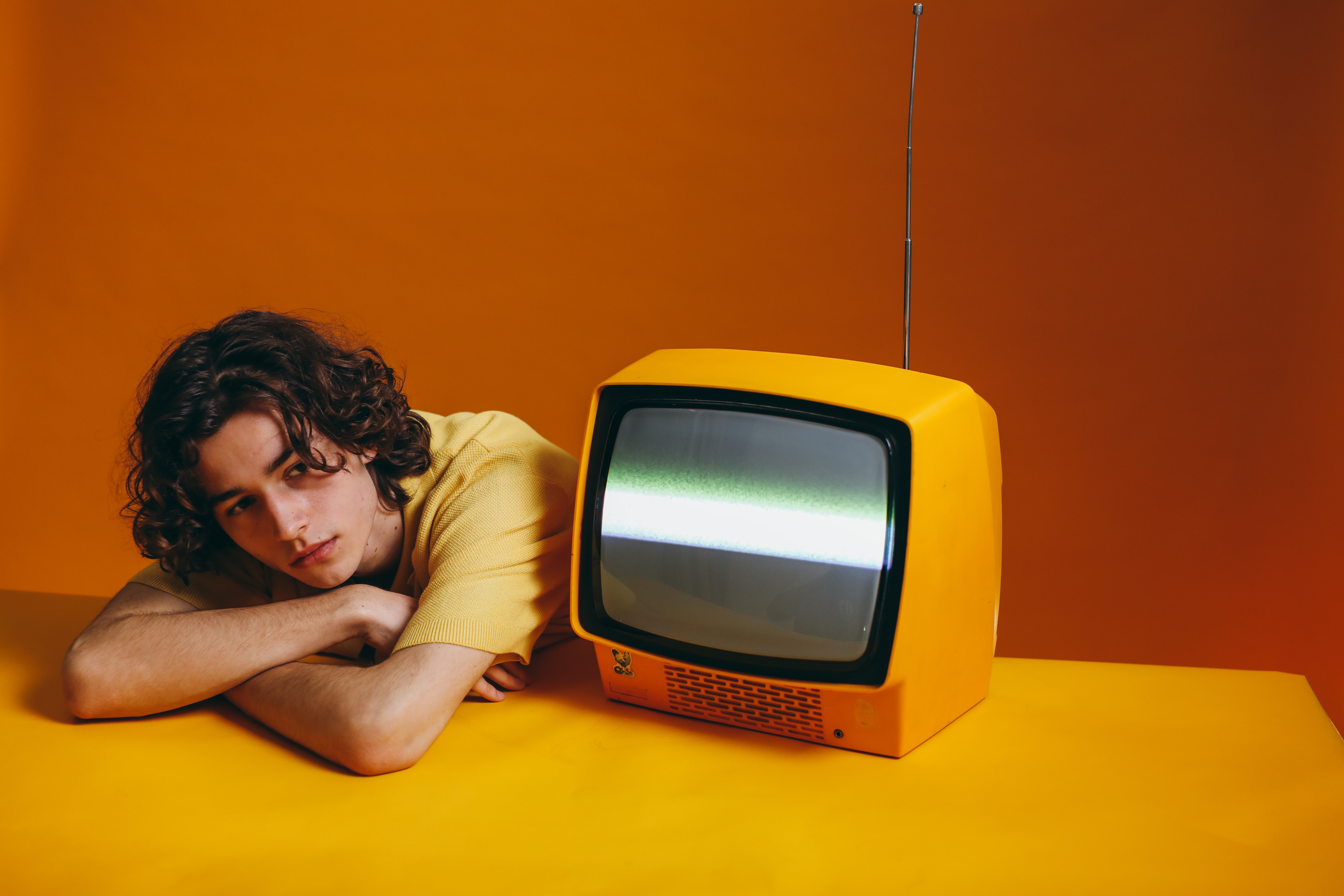 Man beside a yellow television