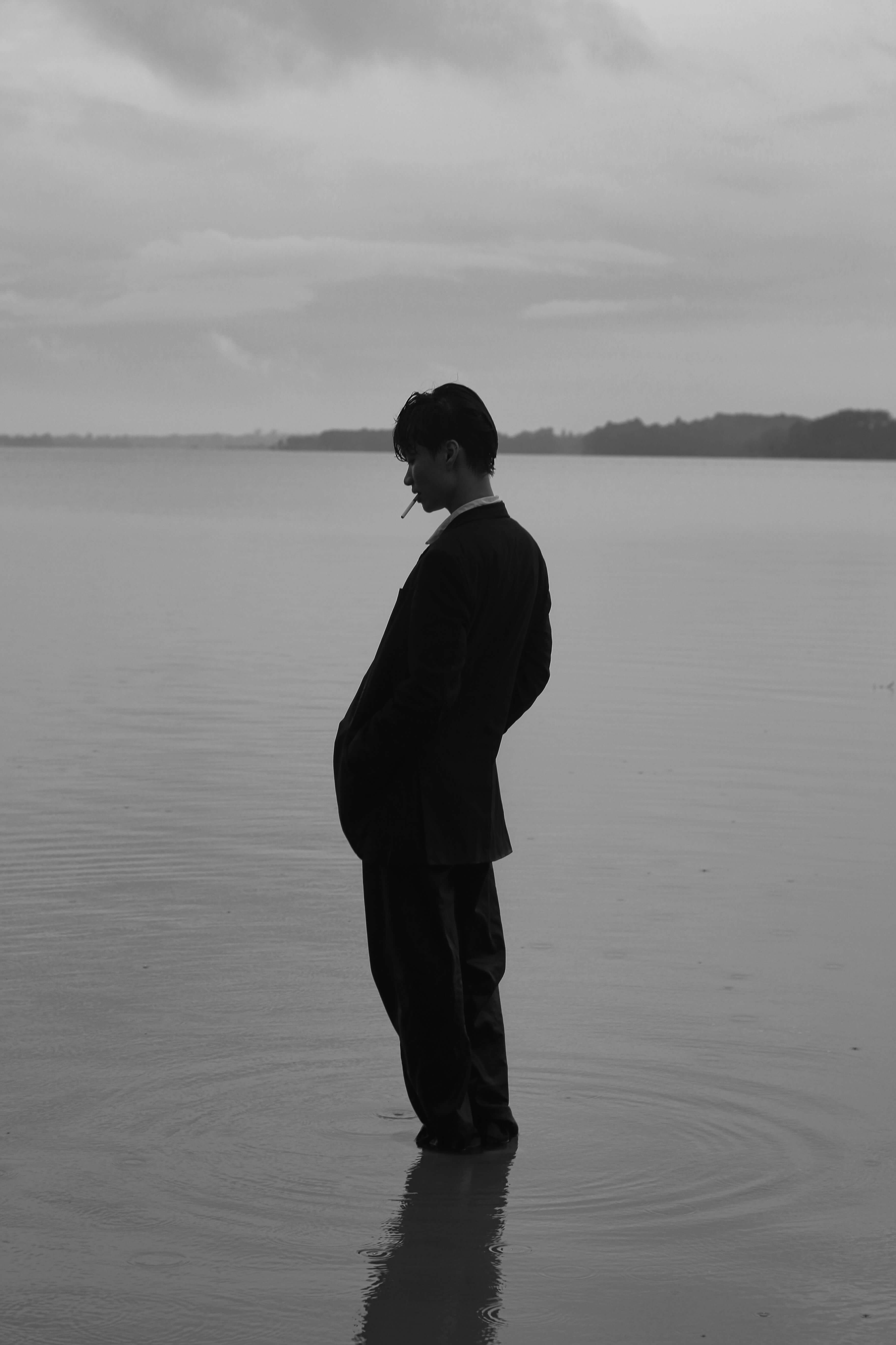 A man in a suit is standing in the water