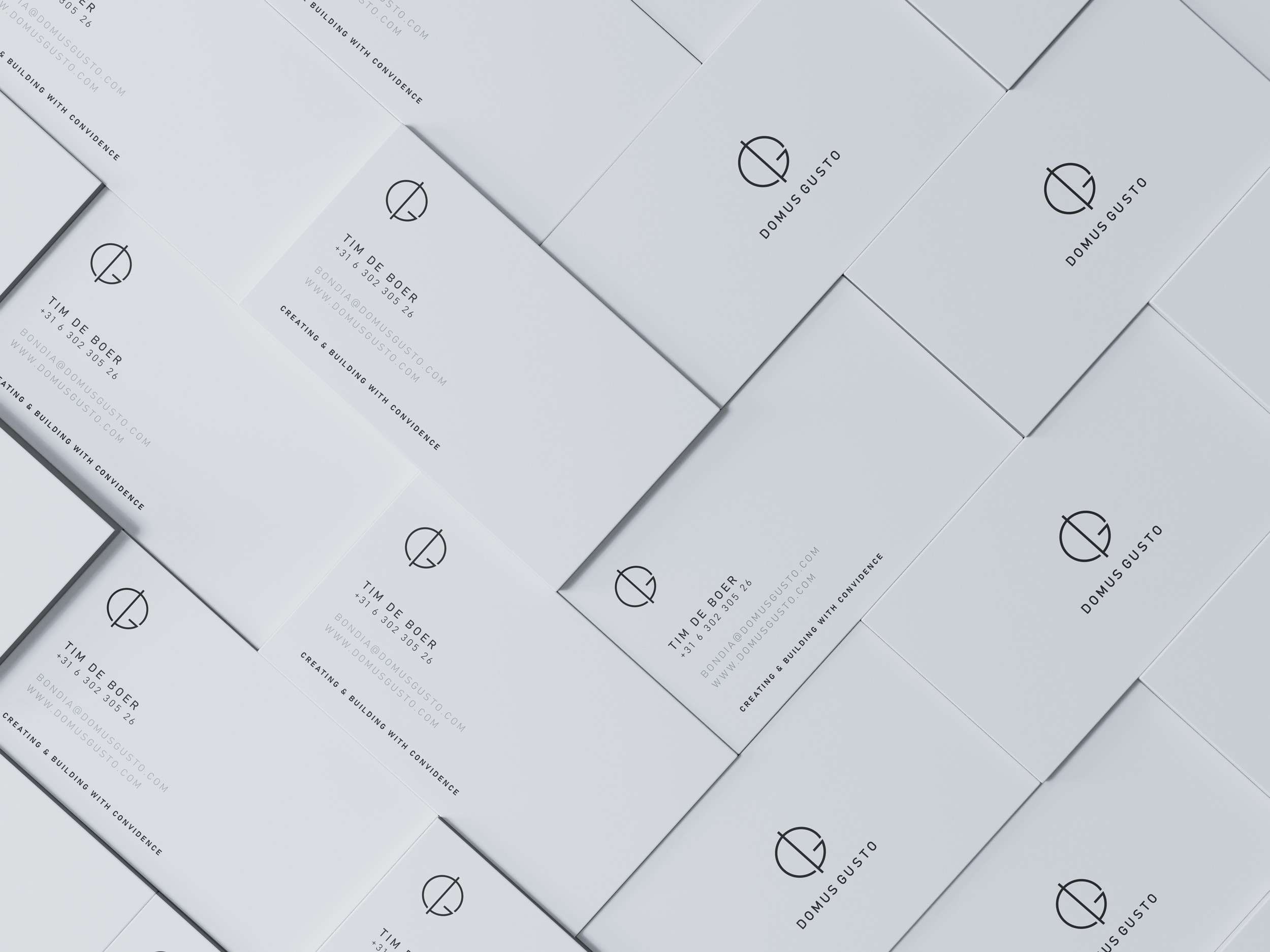 a bunch of buniness cards in white with black print of Domus Gusto