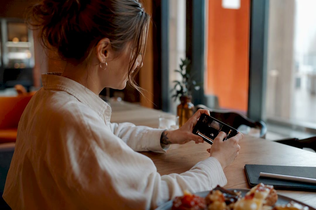 Hand swiping on smartphone editing video clip