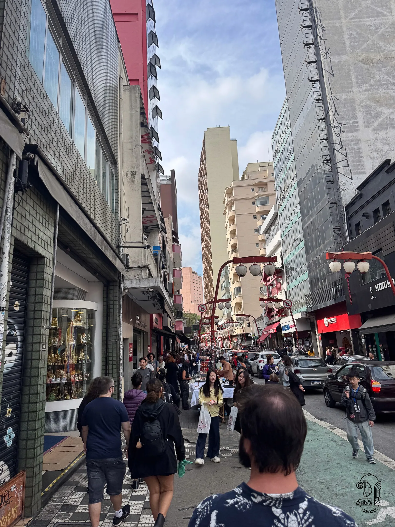 A street in the Japanese neighborhood with lanterns and tall buildings
