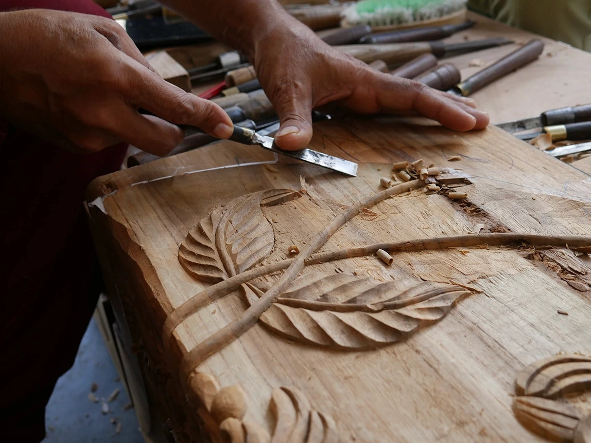 The Conversation Bench - Close up of a the wood carving