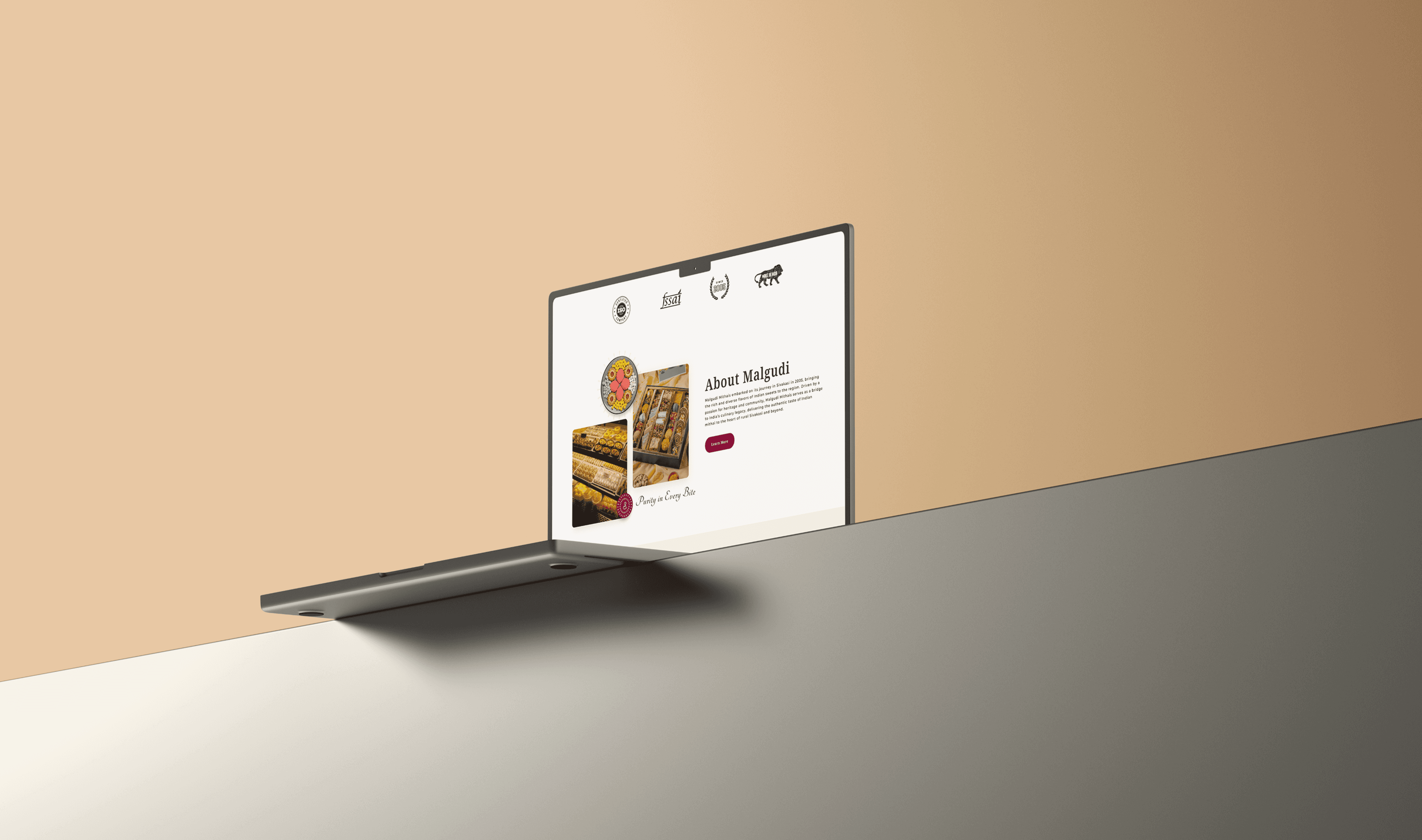 About Malgudi Mithai website section mockup displayed on a modern laptop, highlighting premium Indian sweets, brand certifications, and the story behind the traditional mithai brand.