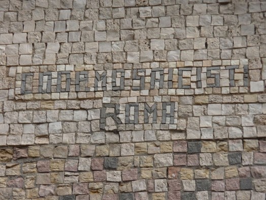 A stone mosaic made into a wall in Rome.