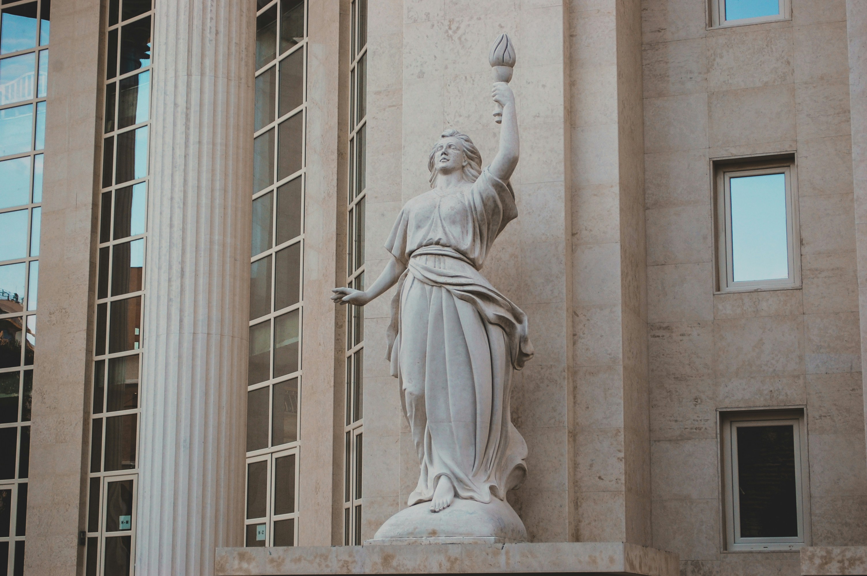 white concrete statue of a woman
