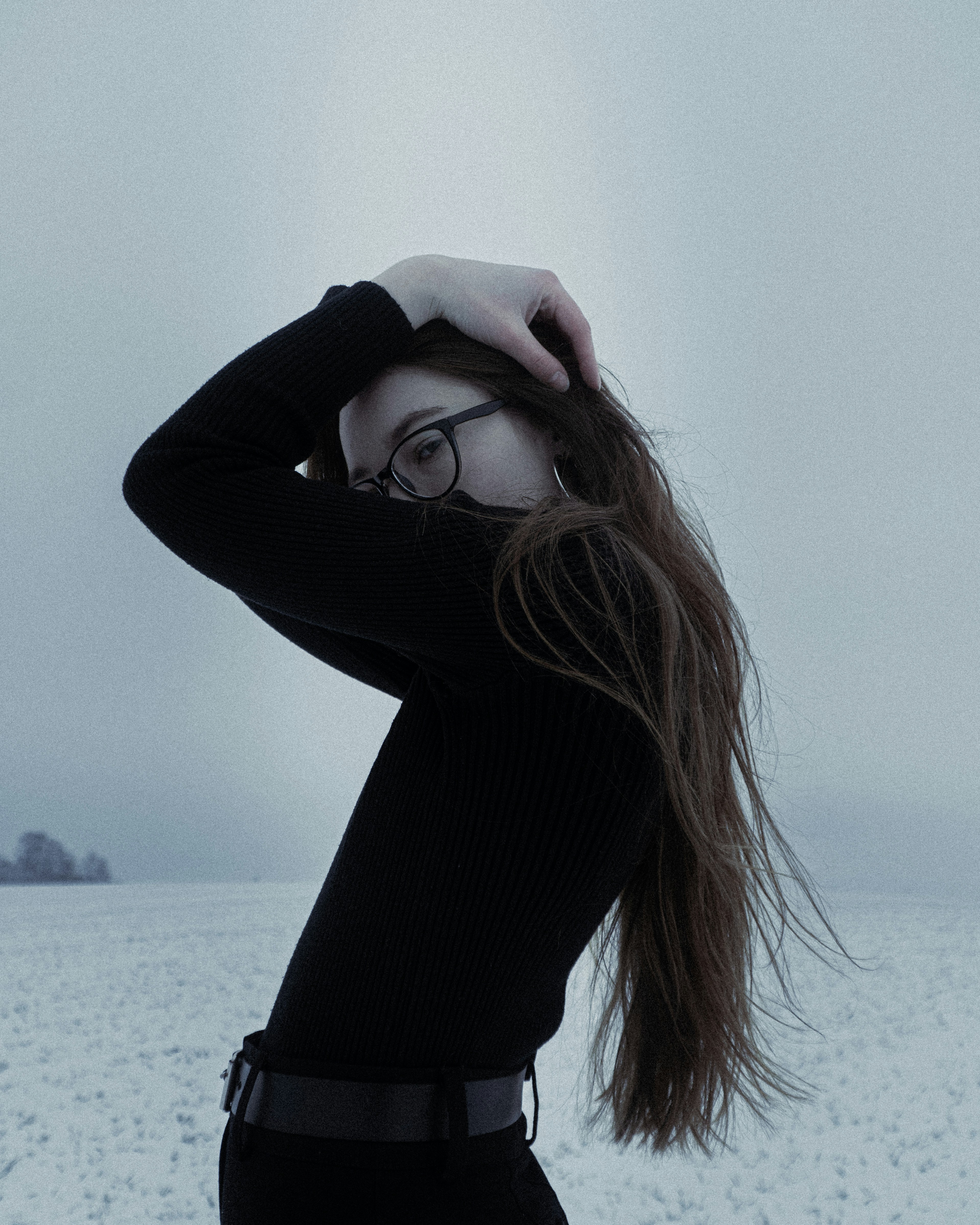 A person with long hair in a snowy field