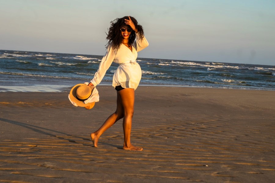 Woman walking along the beach at sunset