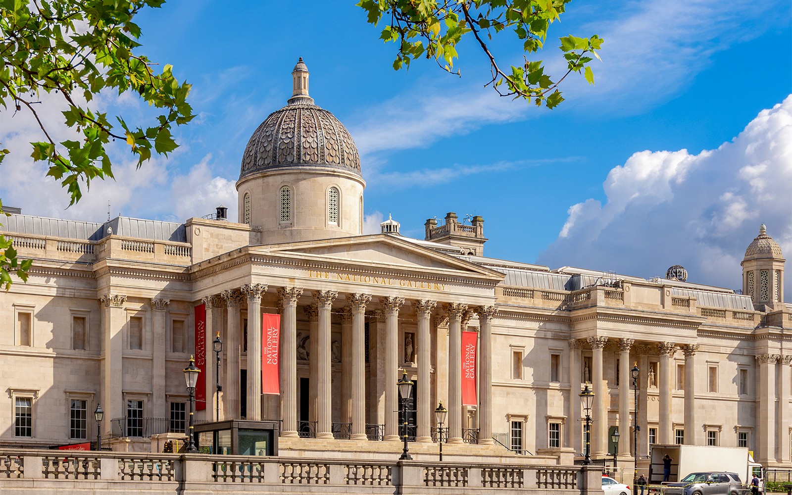 National Gallery London exterior with dome and columns under blue sky.