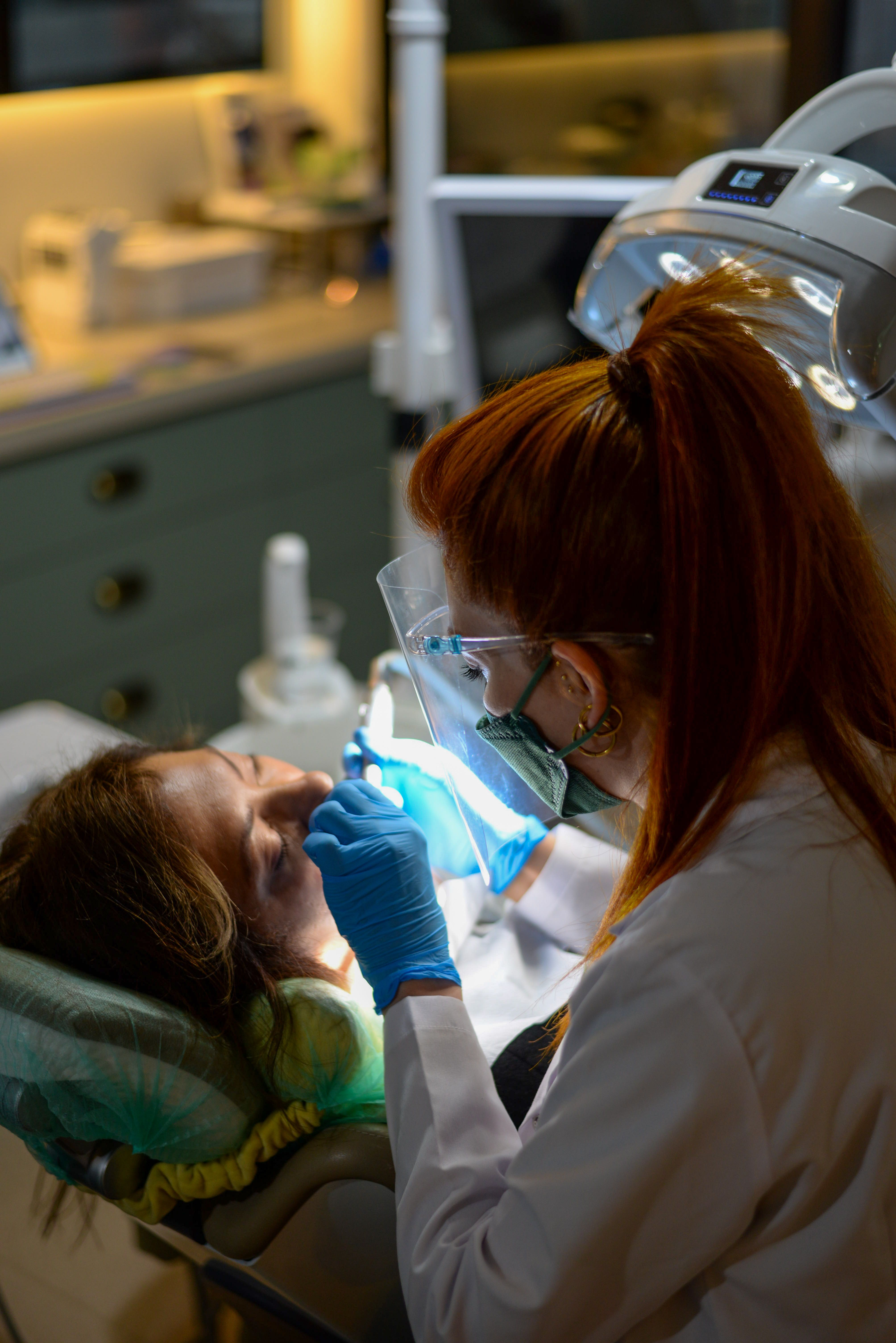 Female Dentists treating the patient's teeth