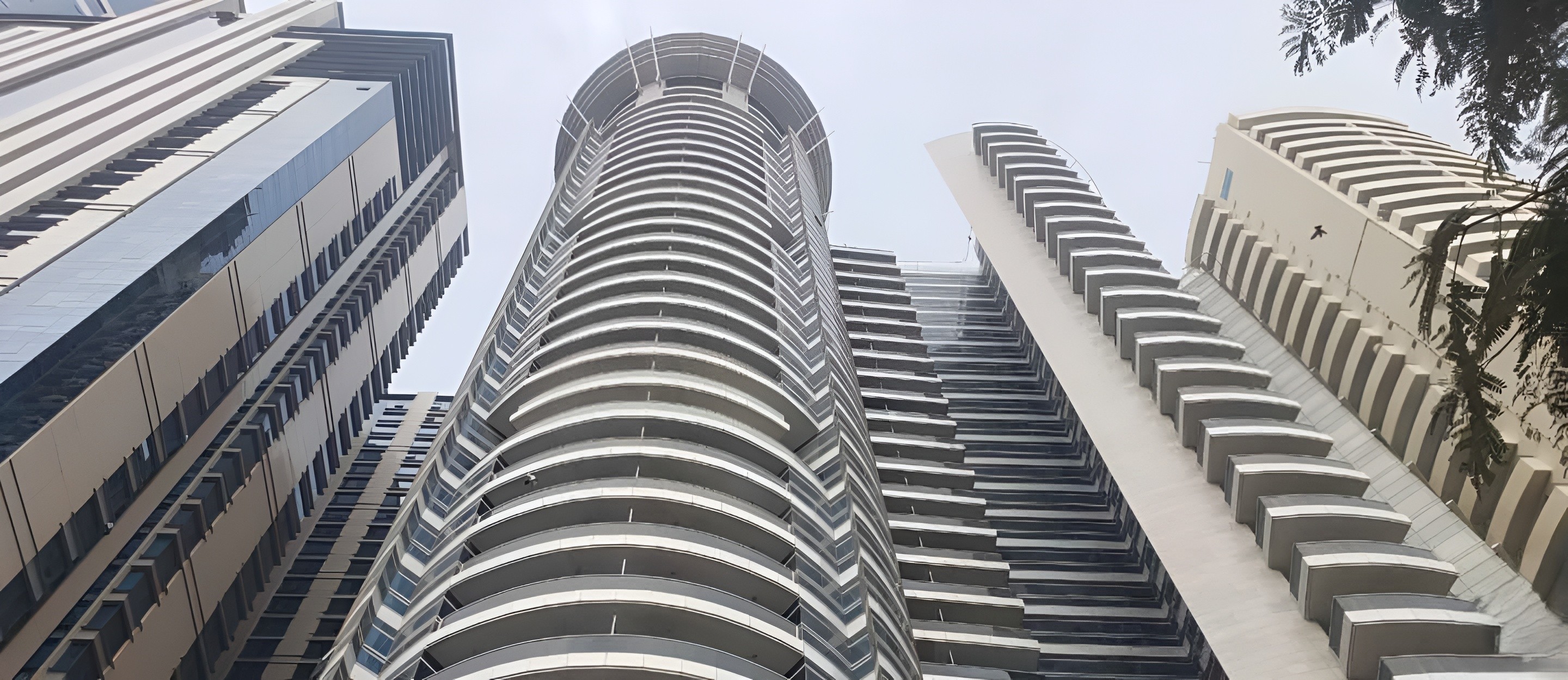 High-rise commercial tower view looking up at the modern circular architectural design.