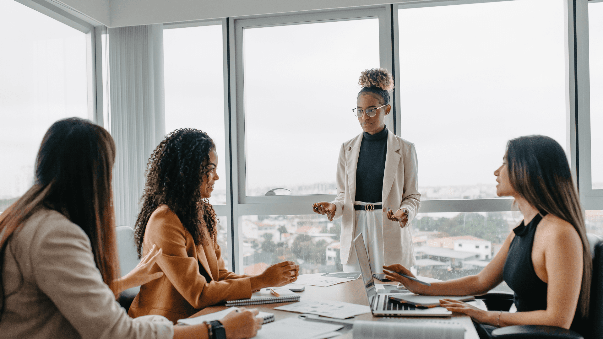 Network switches with glowing lights beside a laptop in a clean tech setup.