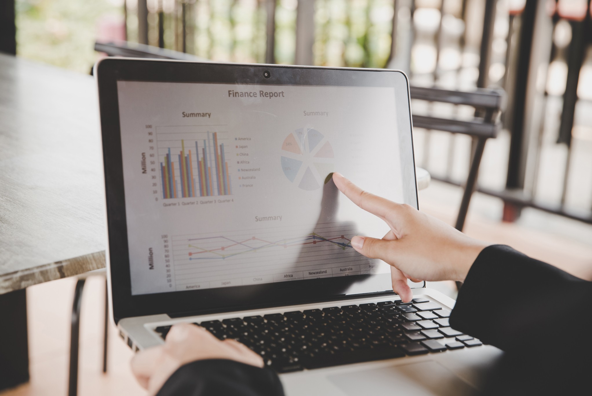 Person analyzing financial reports on a laptop, highlighting financial challenges in healthcare and the importance of data-driven solutions.