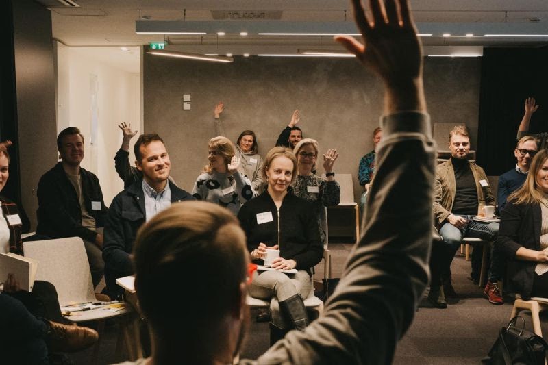 woman sitting while working on laptop and smiling 