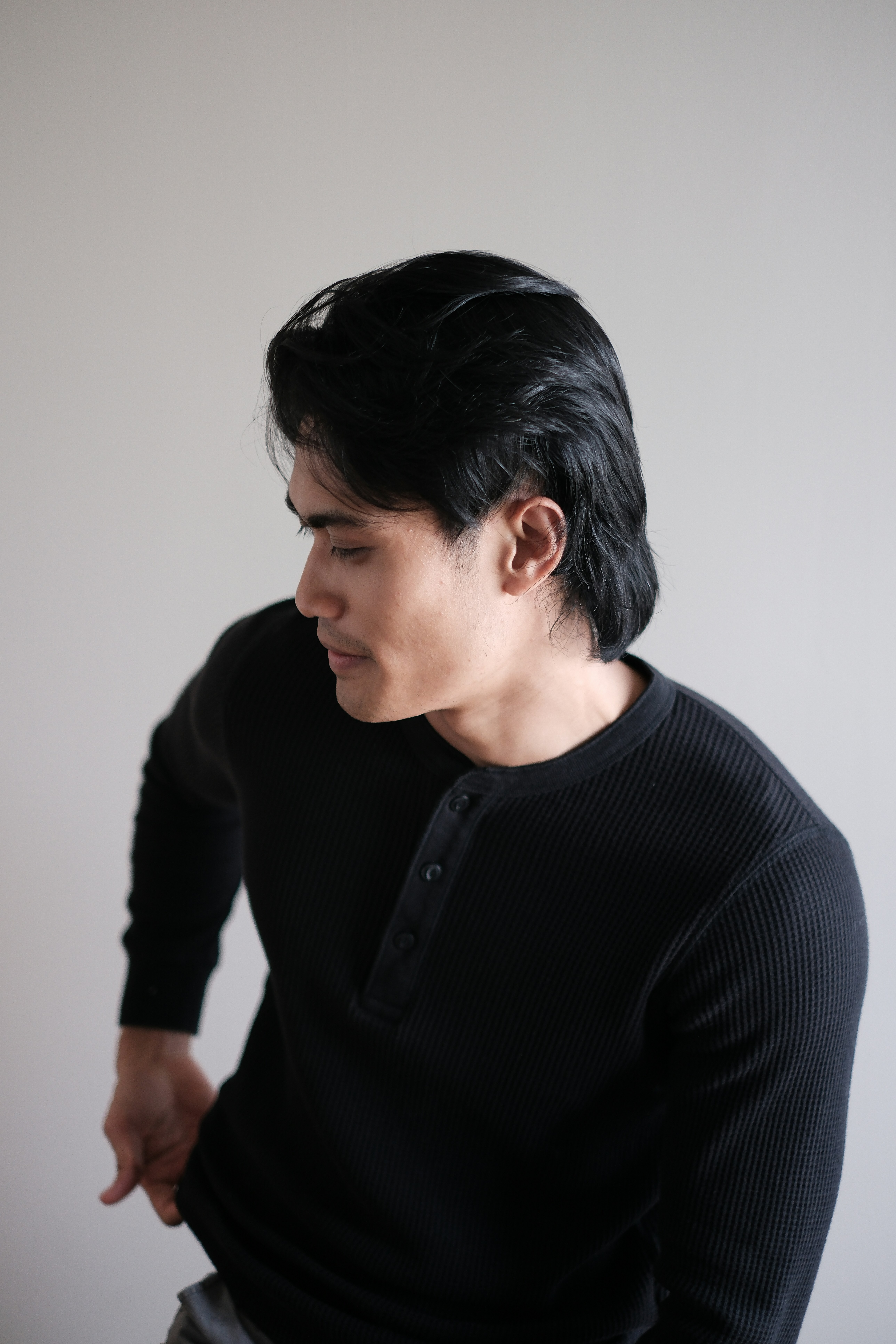 A man with dark hair in a black shirt.