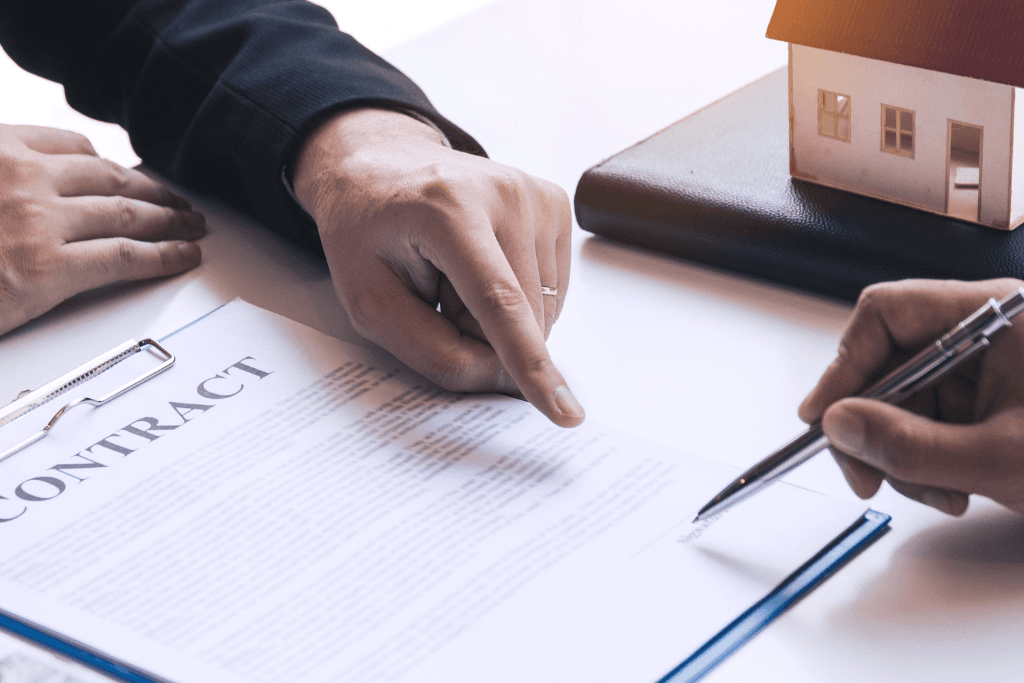 Buyer Signing a Real Estate Contract with a Lawyer 