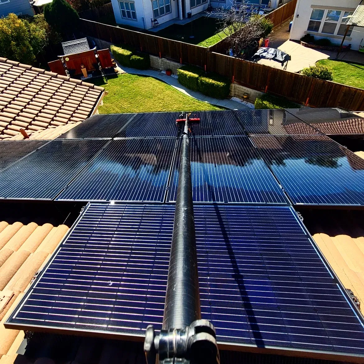 Water-fed pole brush cleaning solar panels | Premier Solar Service