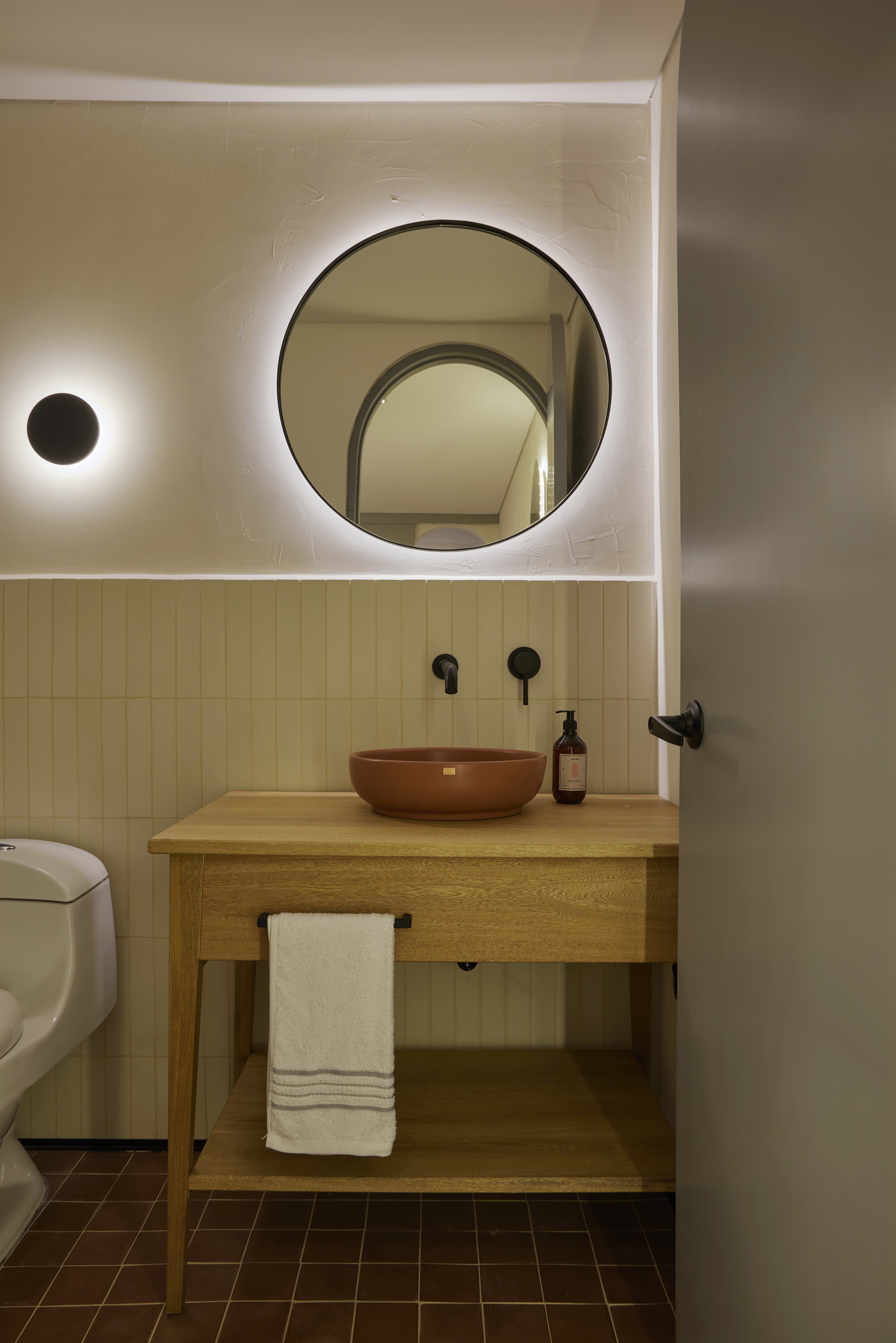 Double-height interior with flowing sculptural forms and warm raking light