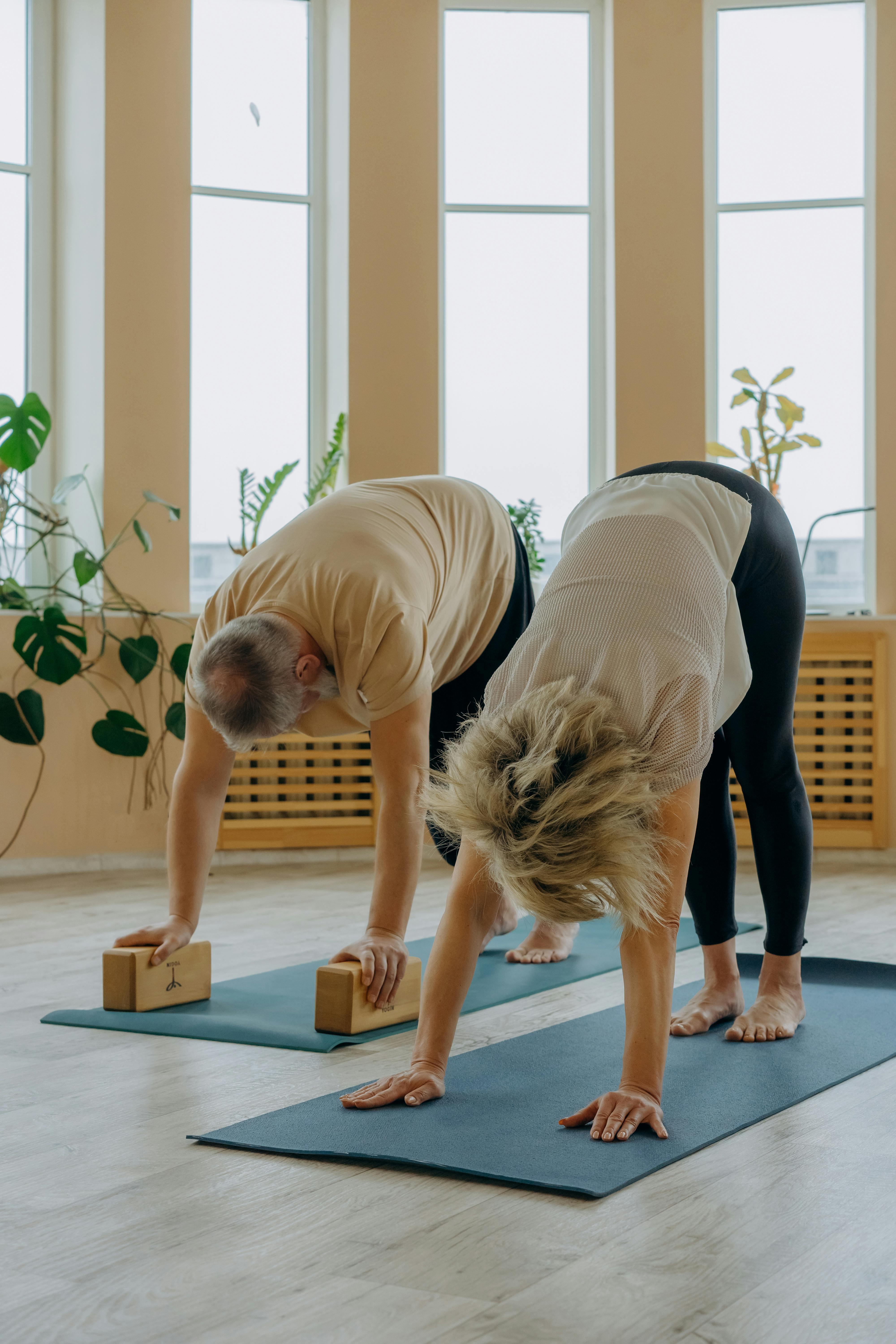 a woman doing a yoga pose on a yoga mat