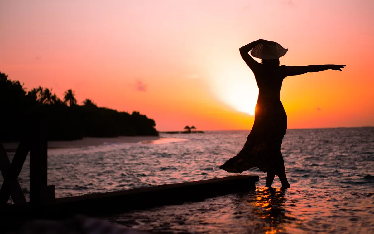 a couple of people standing on top of a mountain