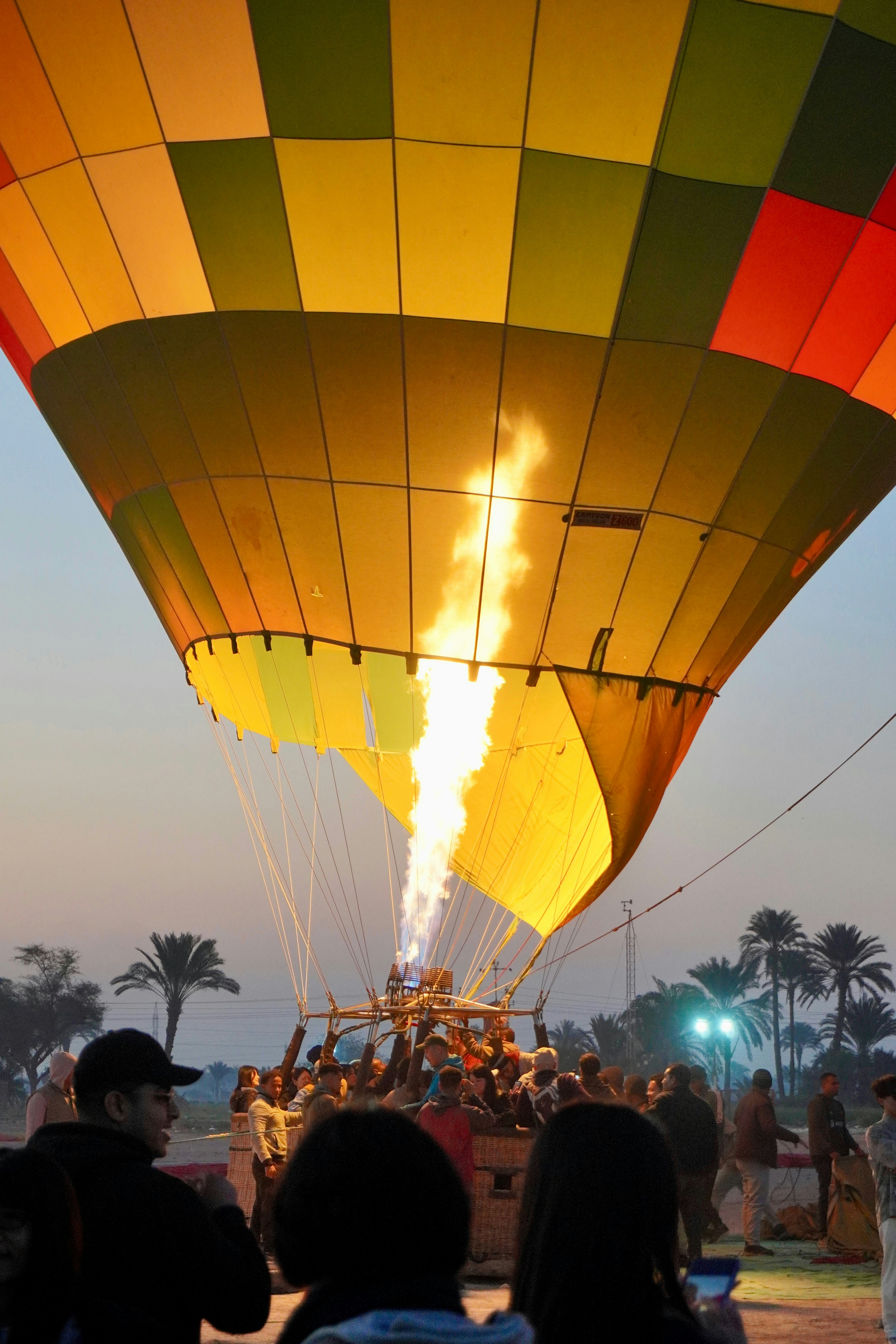 A group of people watching a large hot air balloon