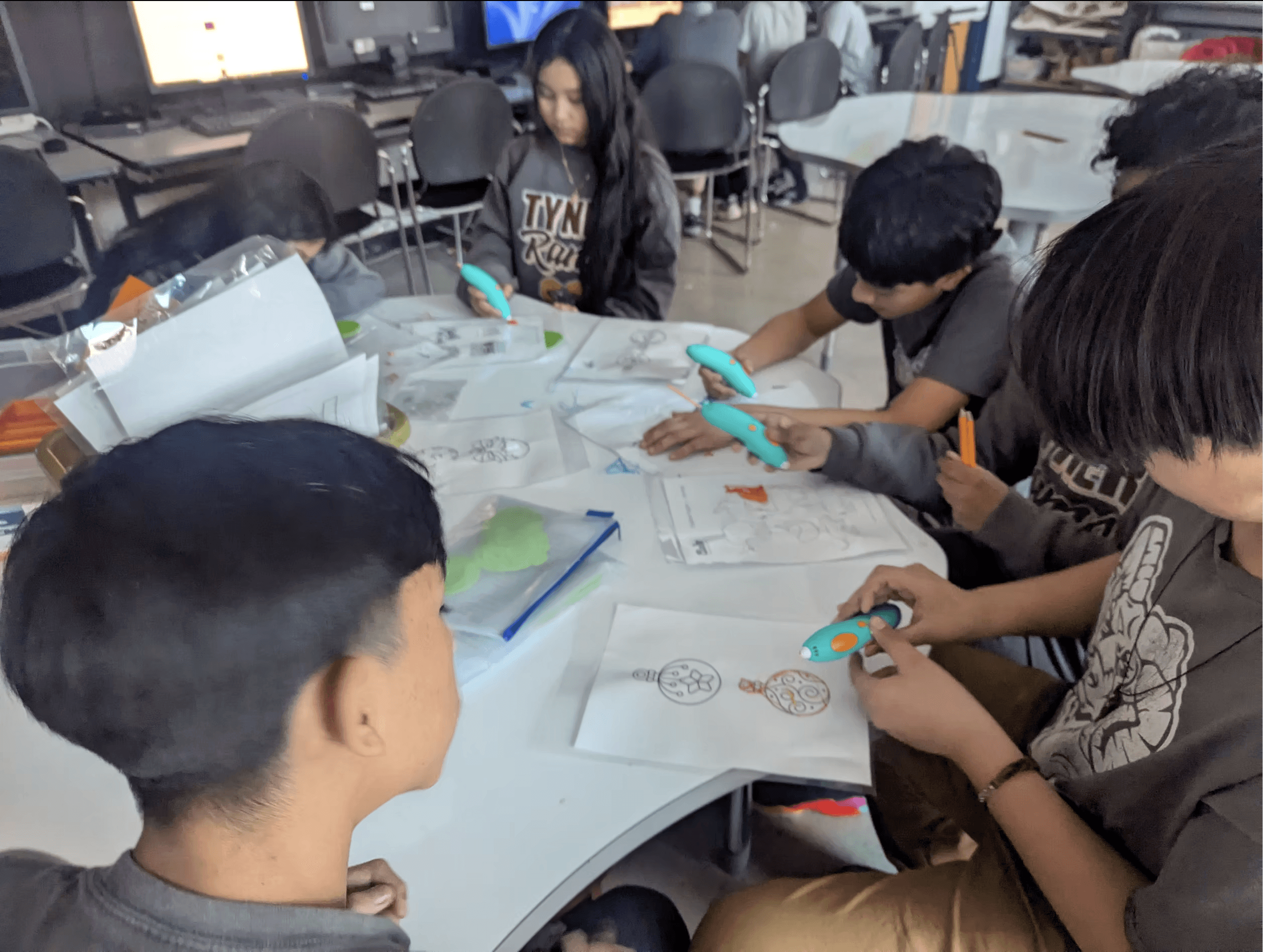 Students working on a project around a table at Tyner Middle/High Academy.