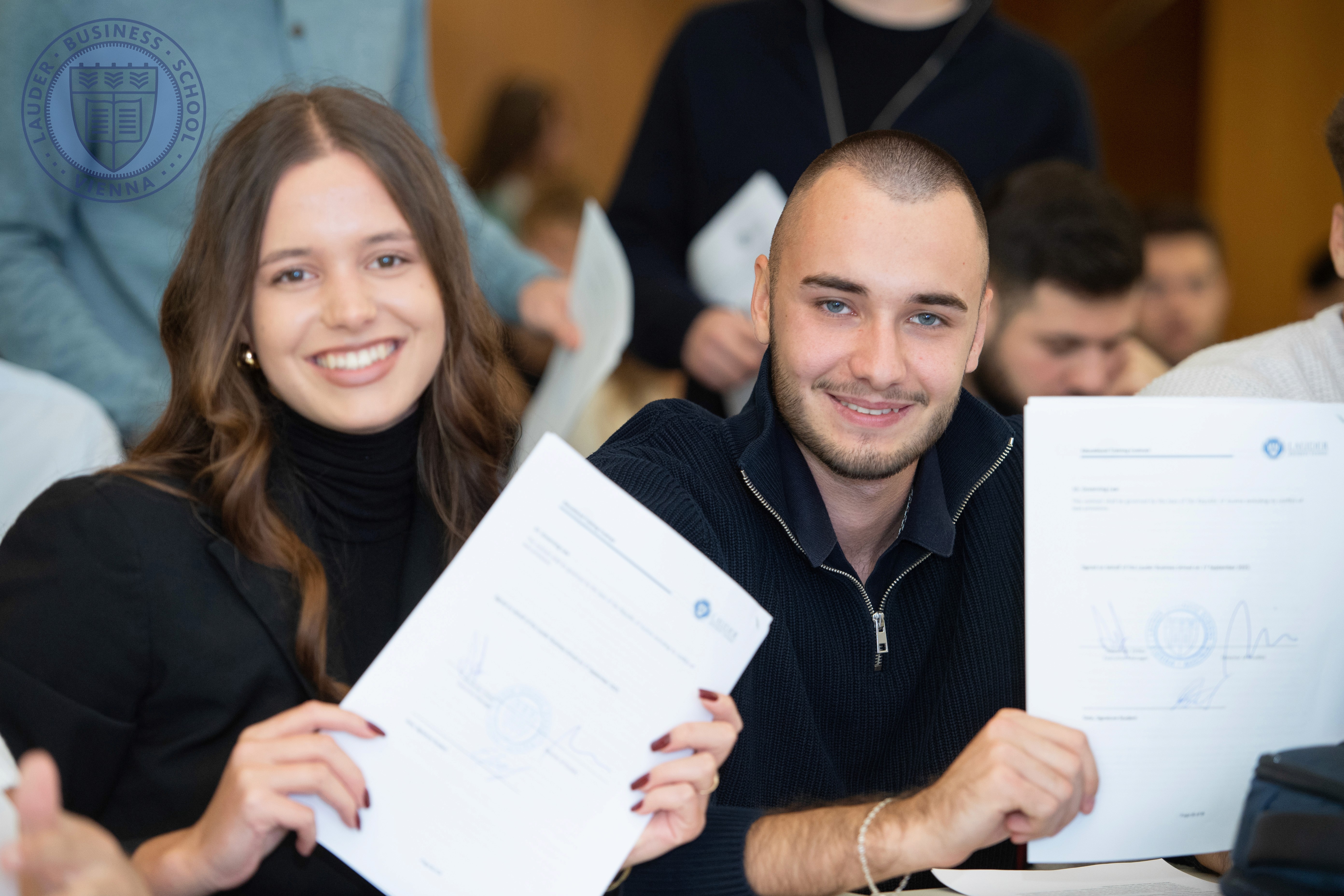 Group of students standing behind an information booth at a campus event at LBS