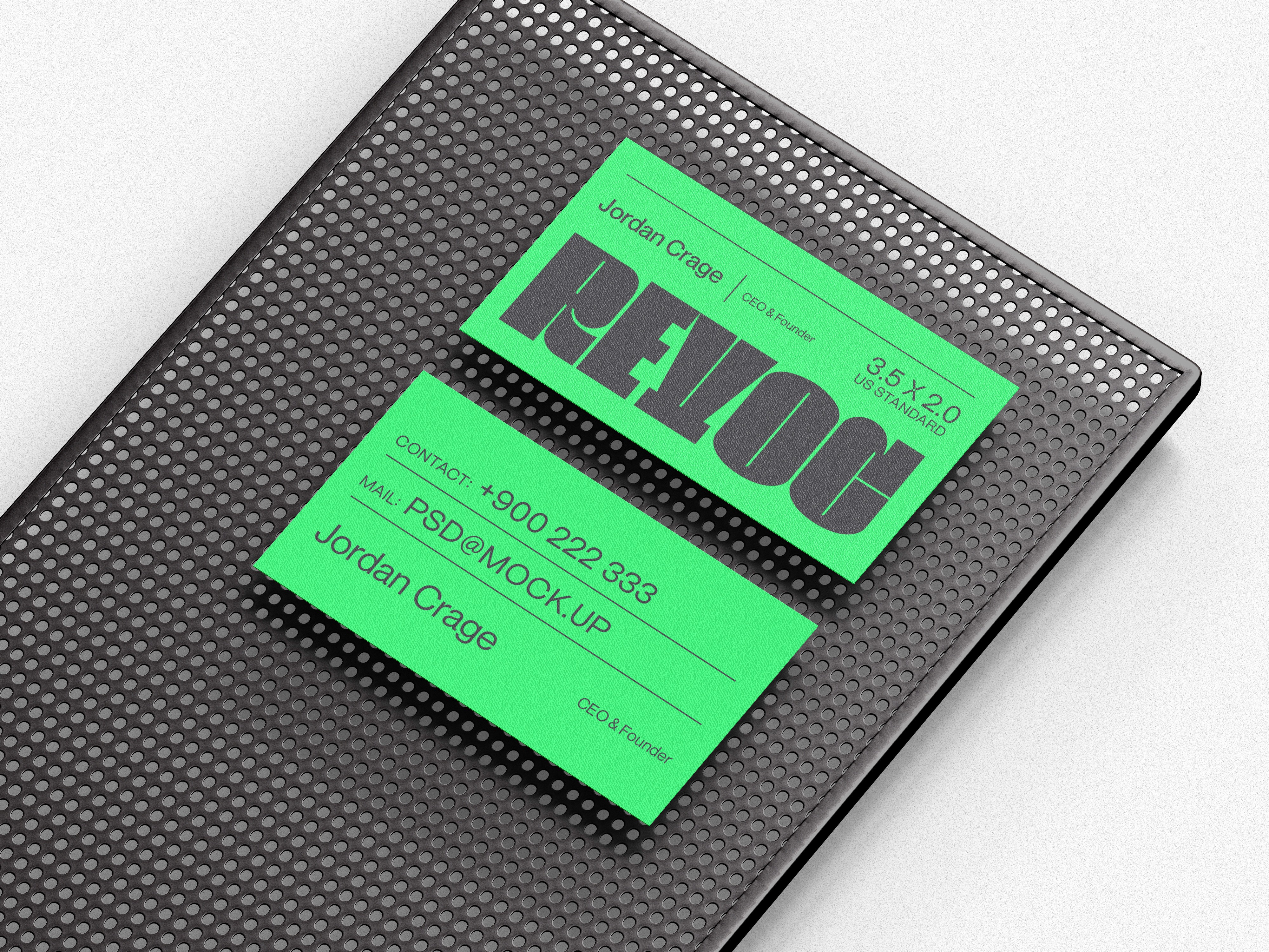 Neon green business cards on a perforated black metal tray.