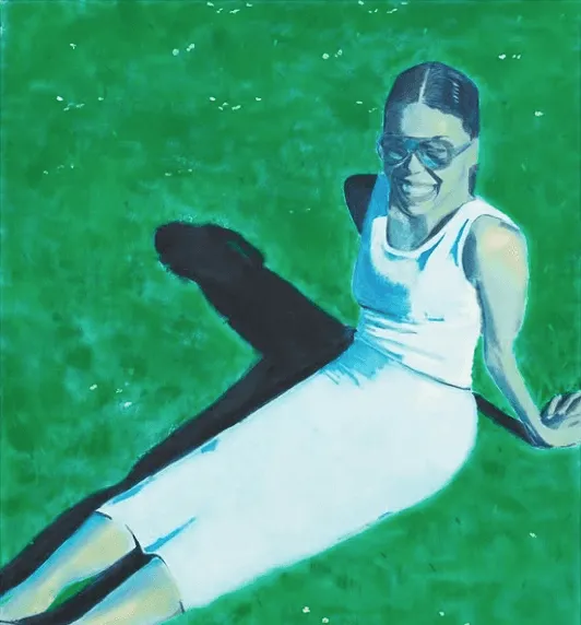 A person in a white outfit sits on bright green grass, casting a long shadow.