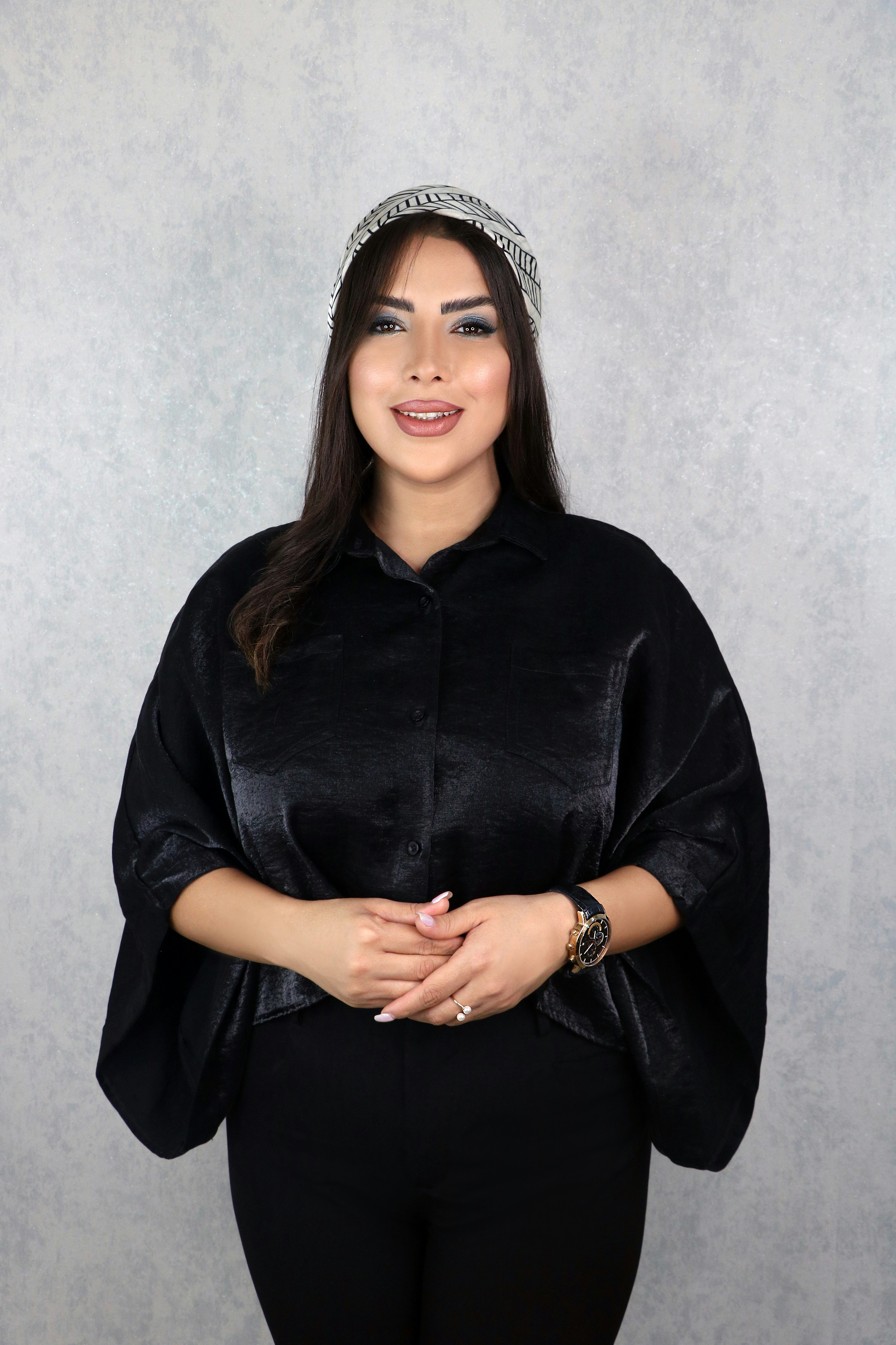 a woman wearing a black top and black pants