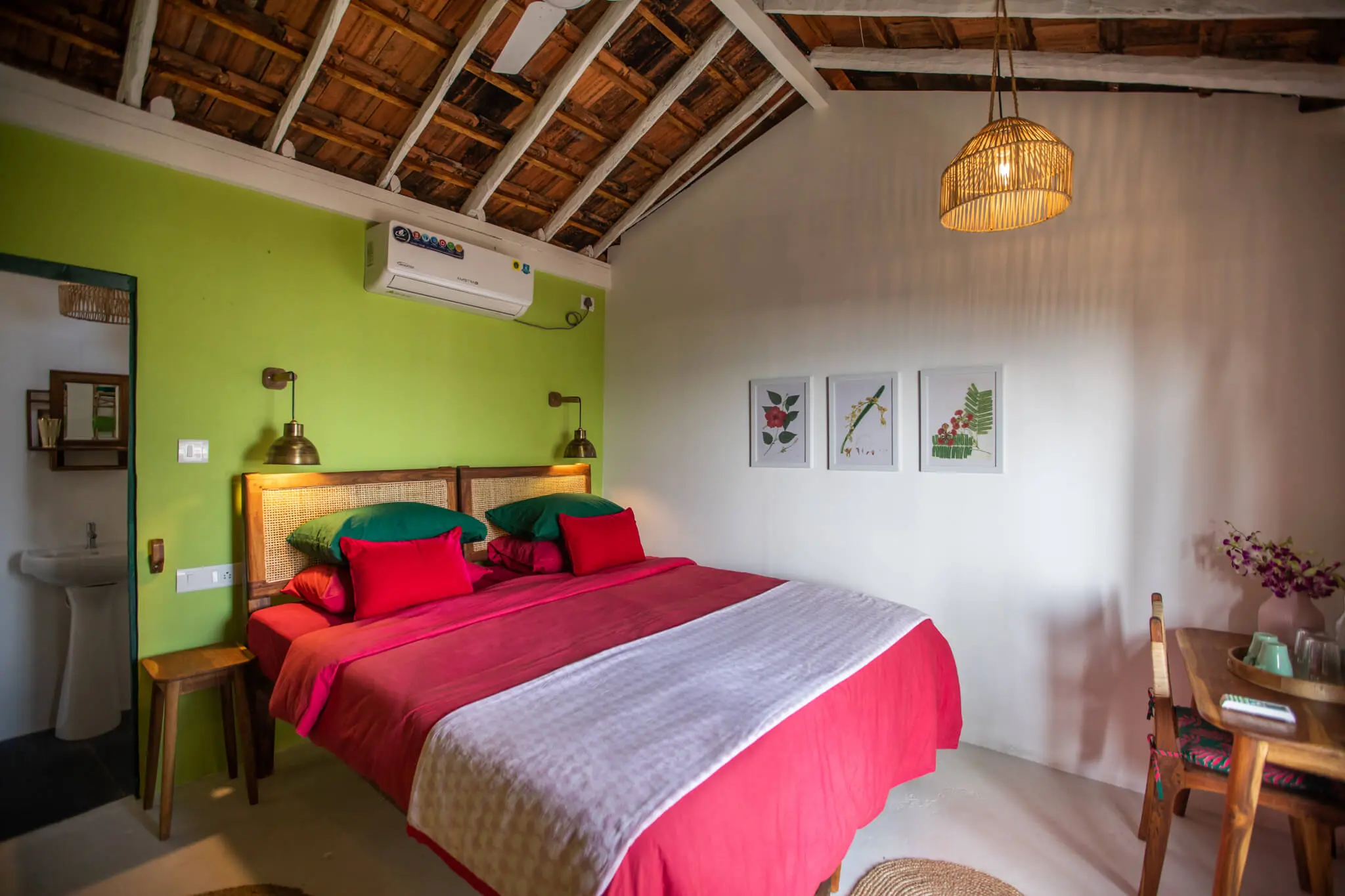 Sea View Hut 6 at Casa Jaali — thatched bedroom in green and red
