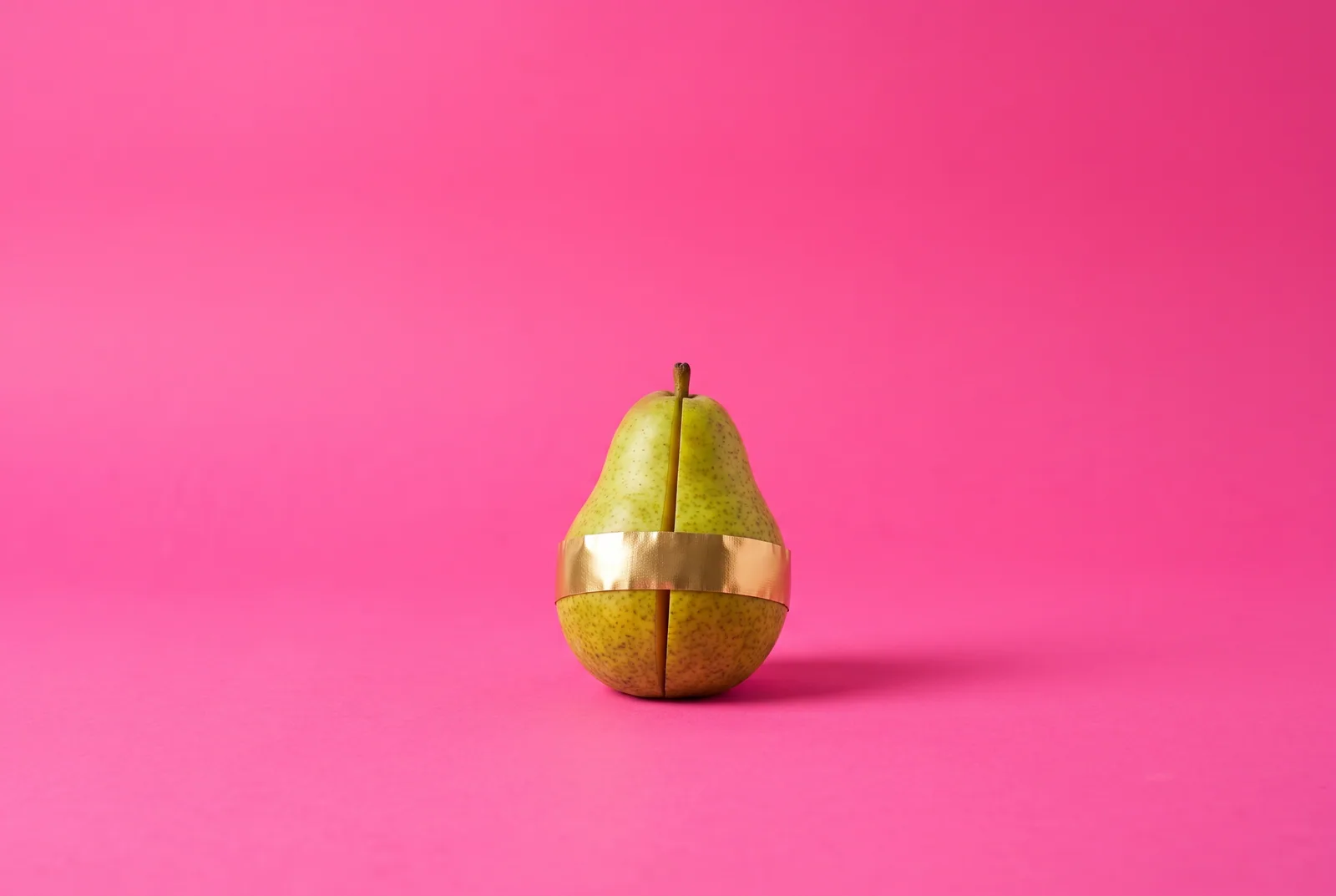 A split pear held together with a band of gold tape, the partner who used porn rebuilding trust
