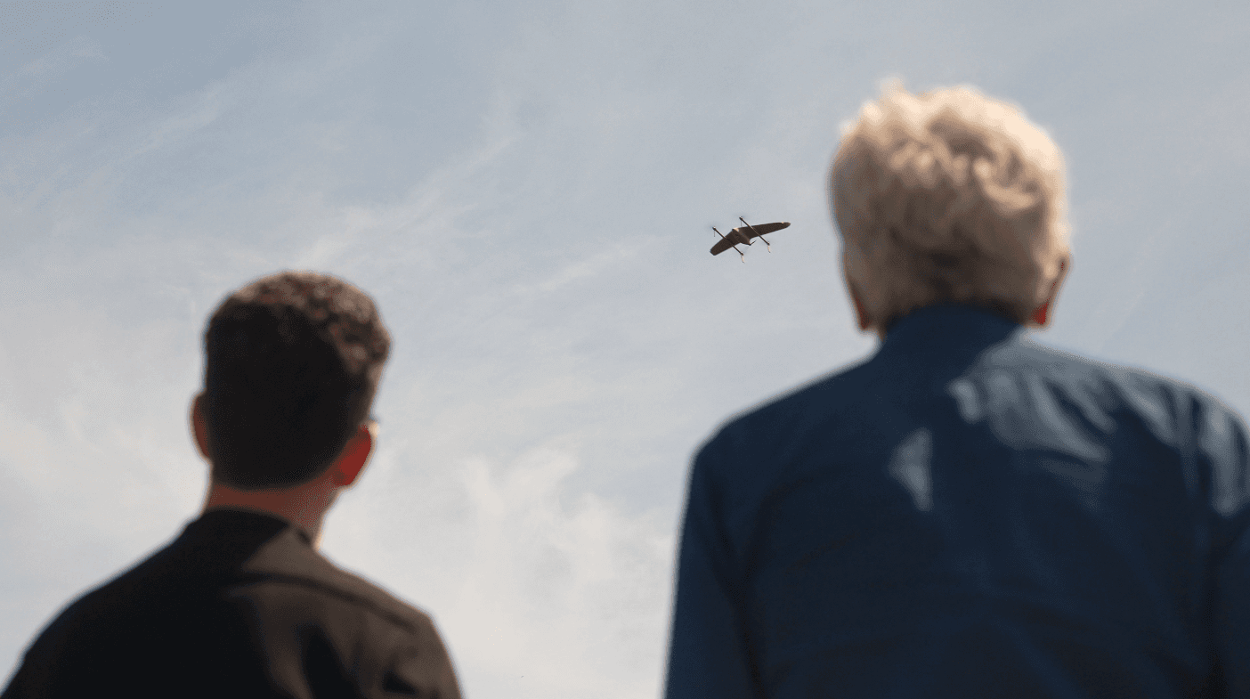people watching a drone