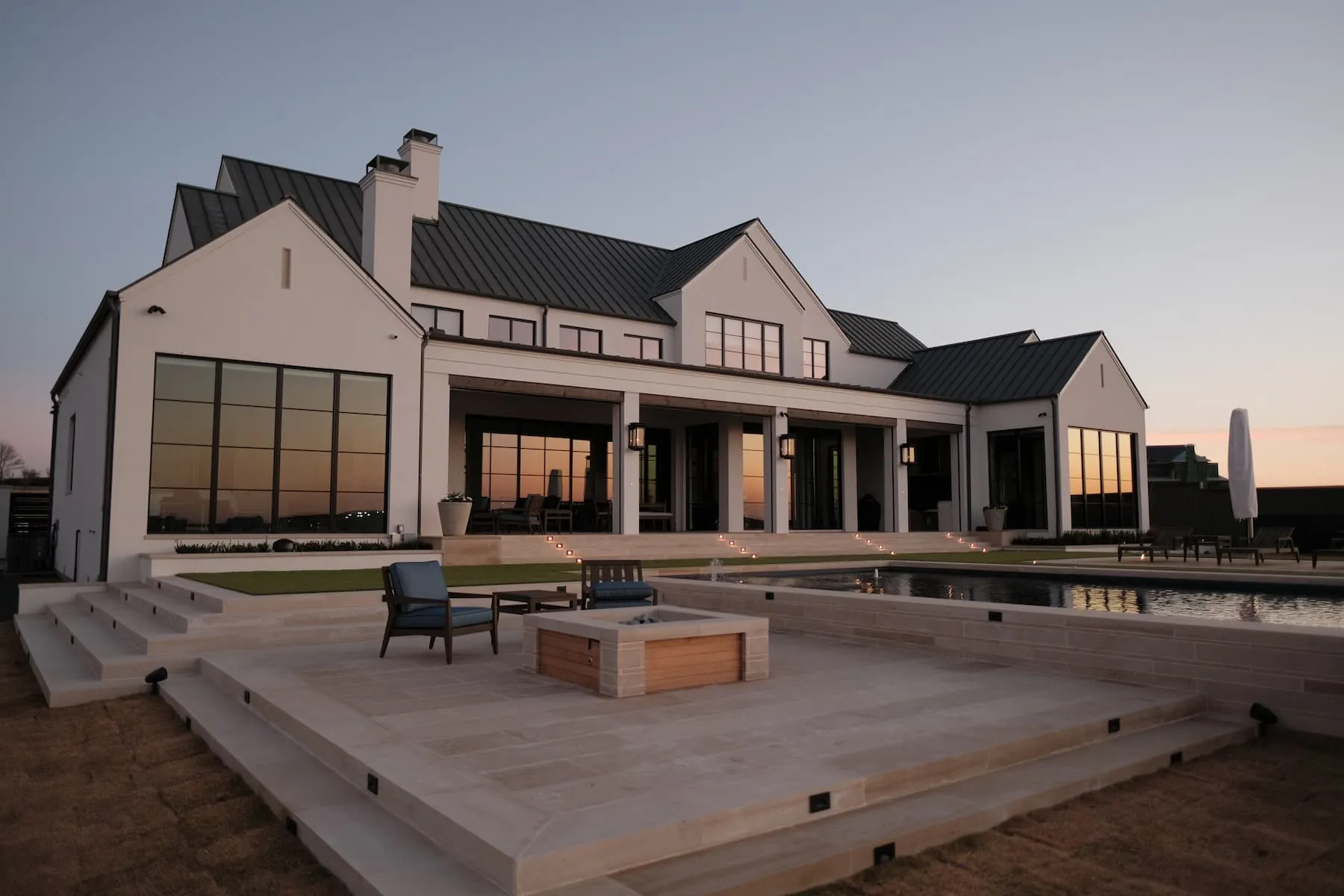 Luxury outdoor living, pool and custom fire feature and pool at golden hour, Blount Designs Frisco TX