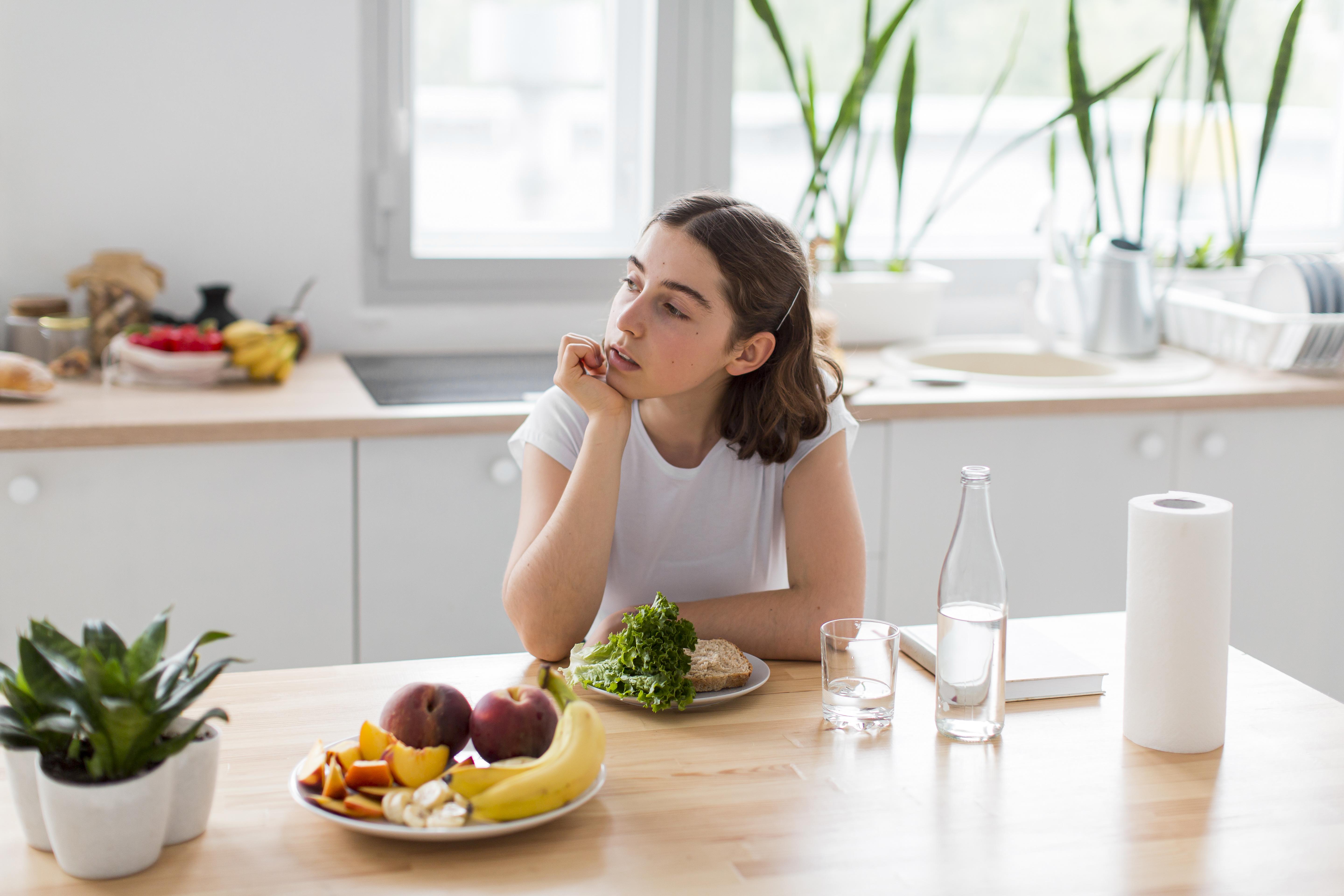 a young woman sitting in the kitchen