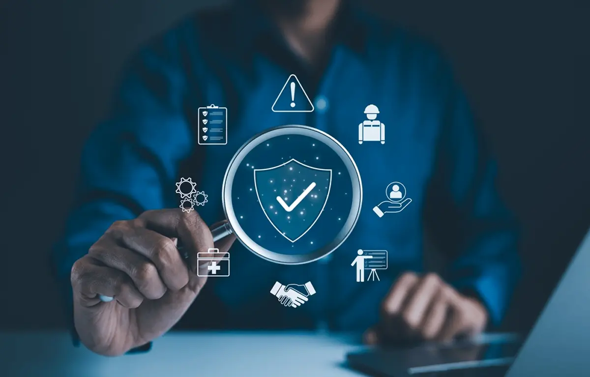 Digital magnifying glass inspecting security, compliance, and safety icons.