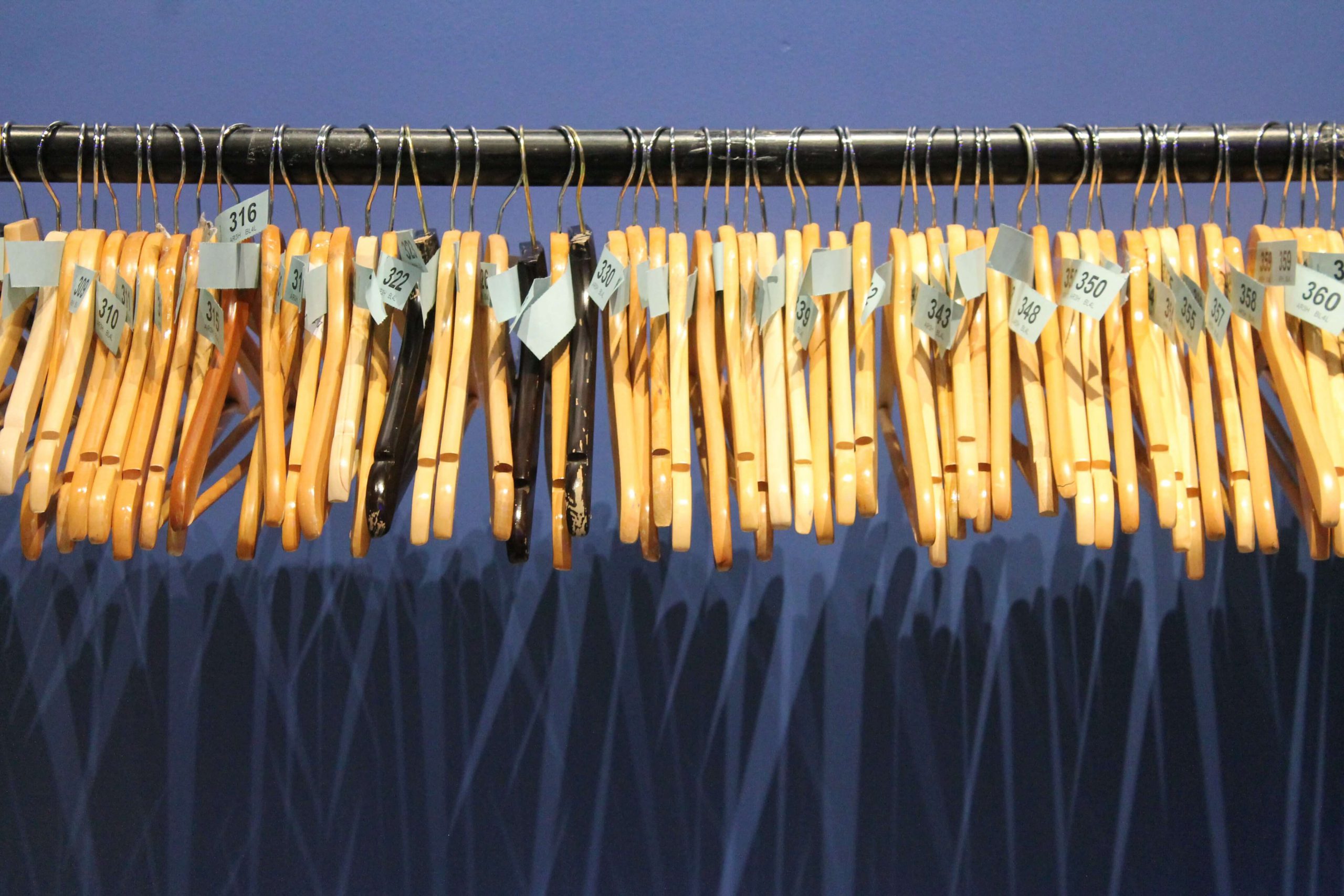 Organized clothing racks displaying numbered garments in Aritzia's signature boutique retail environment.