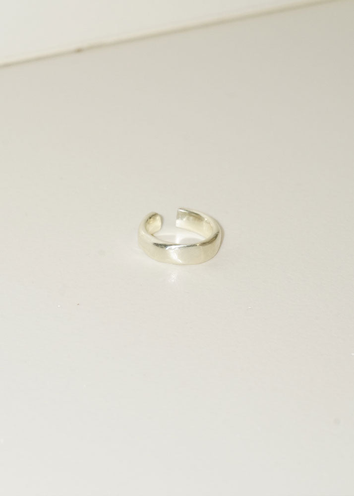 Silver ring on a light beige background