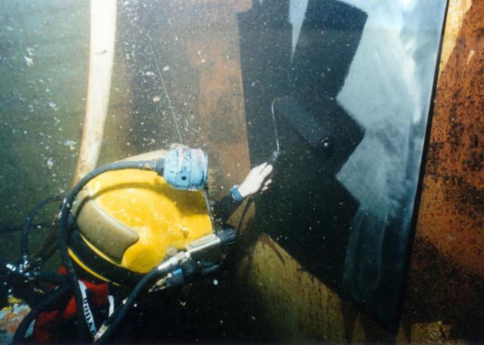 a diver painting underwater