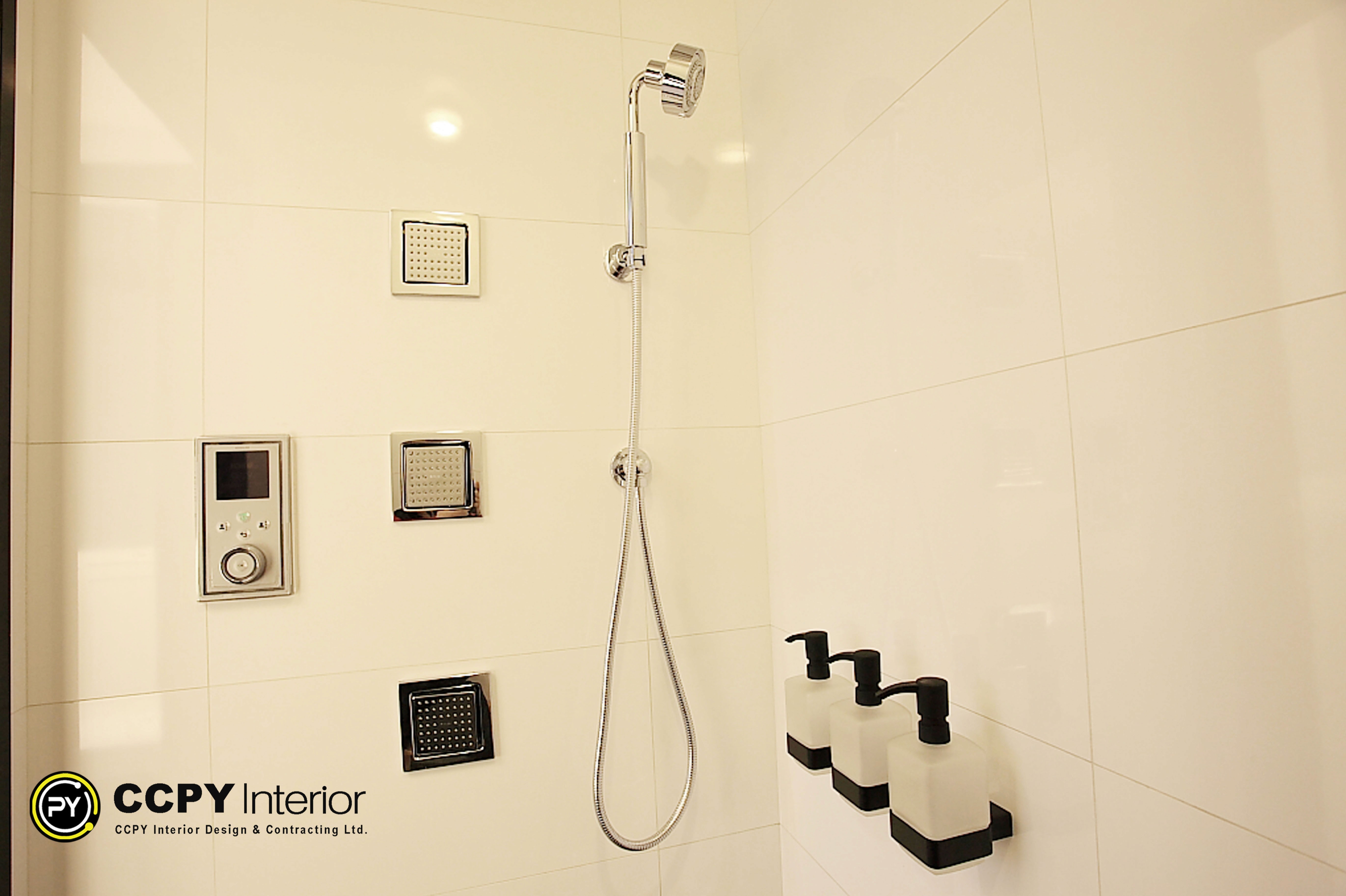 Wall-mounted chrome shower set with three square body jets and a handheld spray in a luxury mansion Perkins Road bathroom.