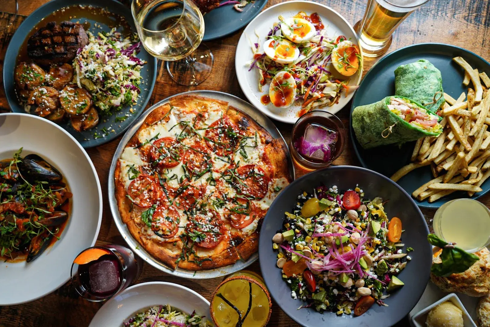 Shared plates including pizza and salads at South Village Grille