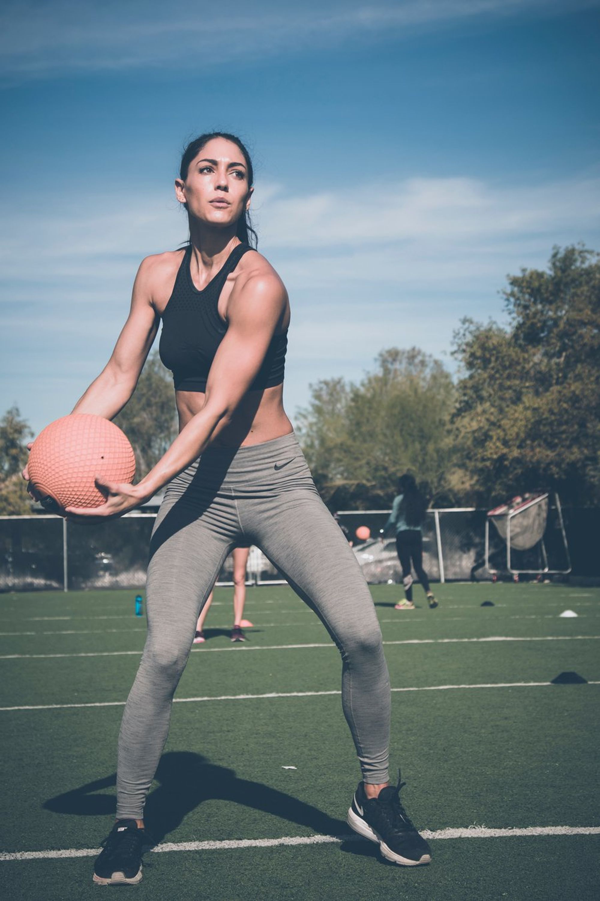 A woman holding a medicine ball