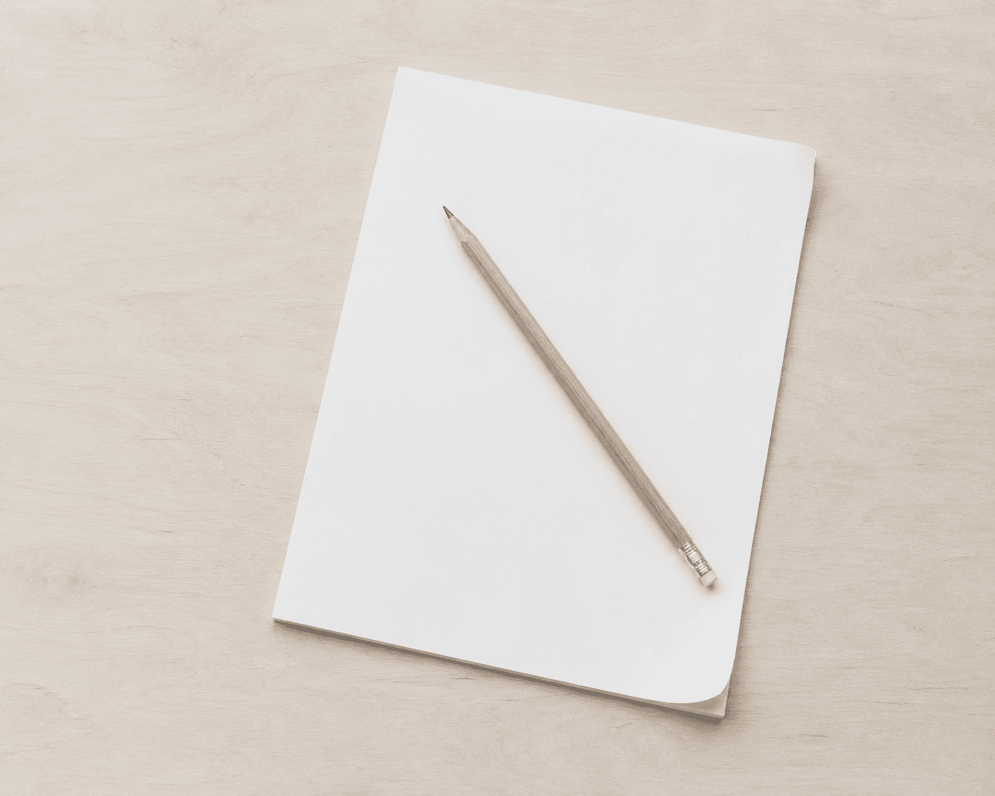 Pencil resting on blank notepad suggesting the difficulty of starting structure-based plans with ADHD