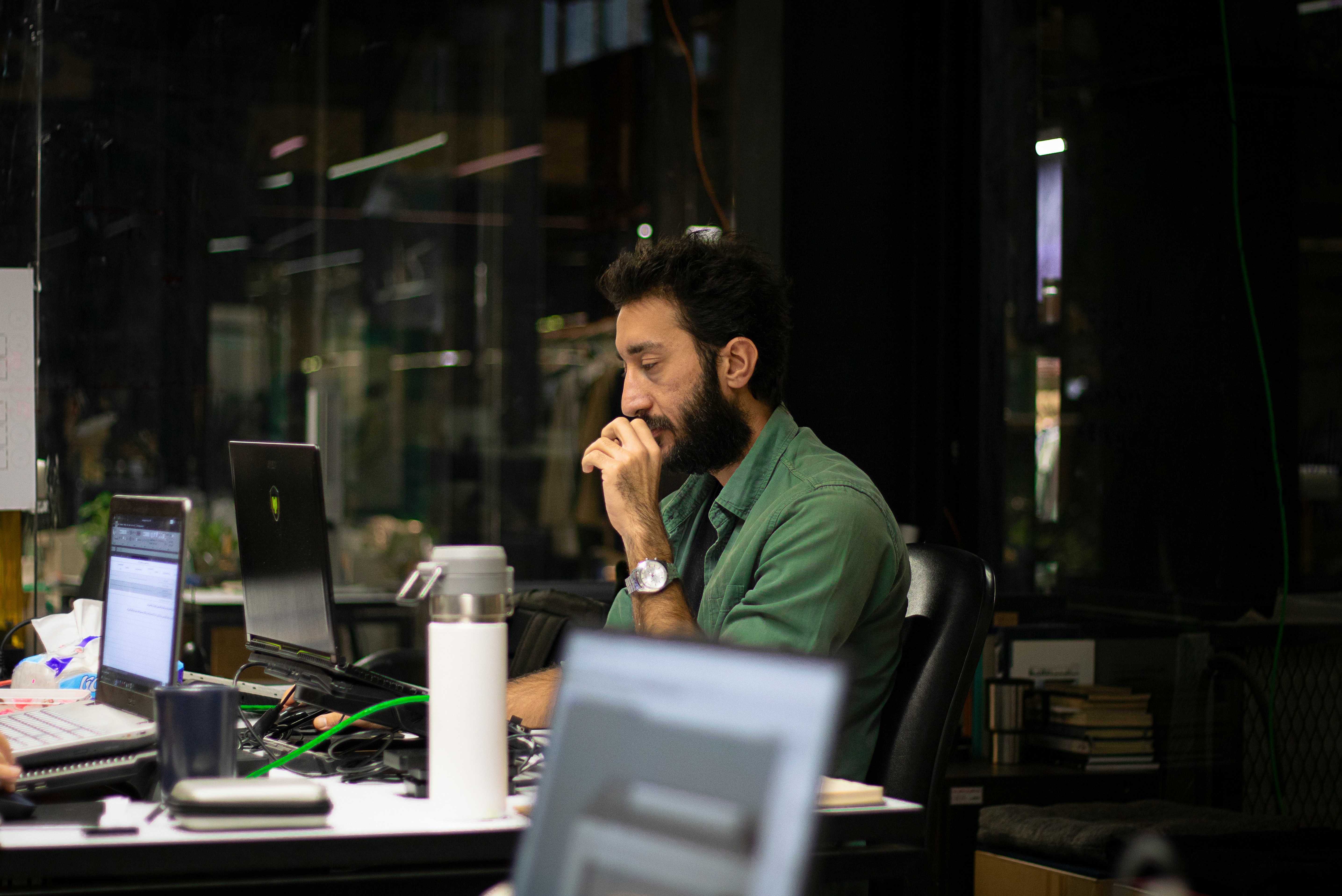 a man sitting in front of a laptop computer