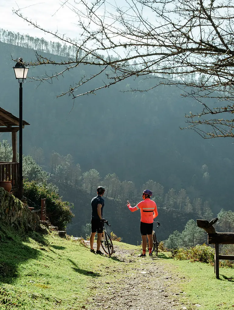 Two cyclists resting in a rural village in Portugal.