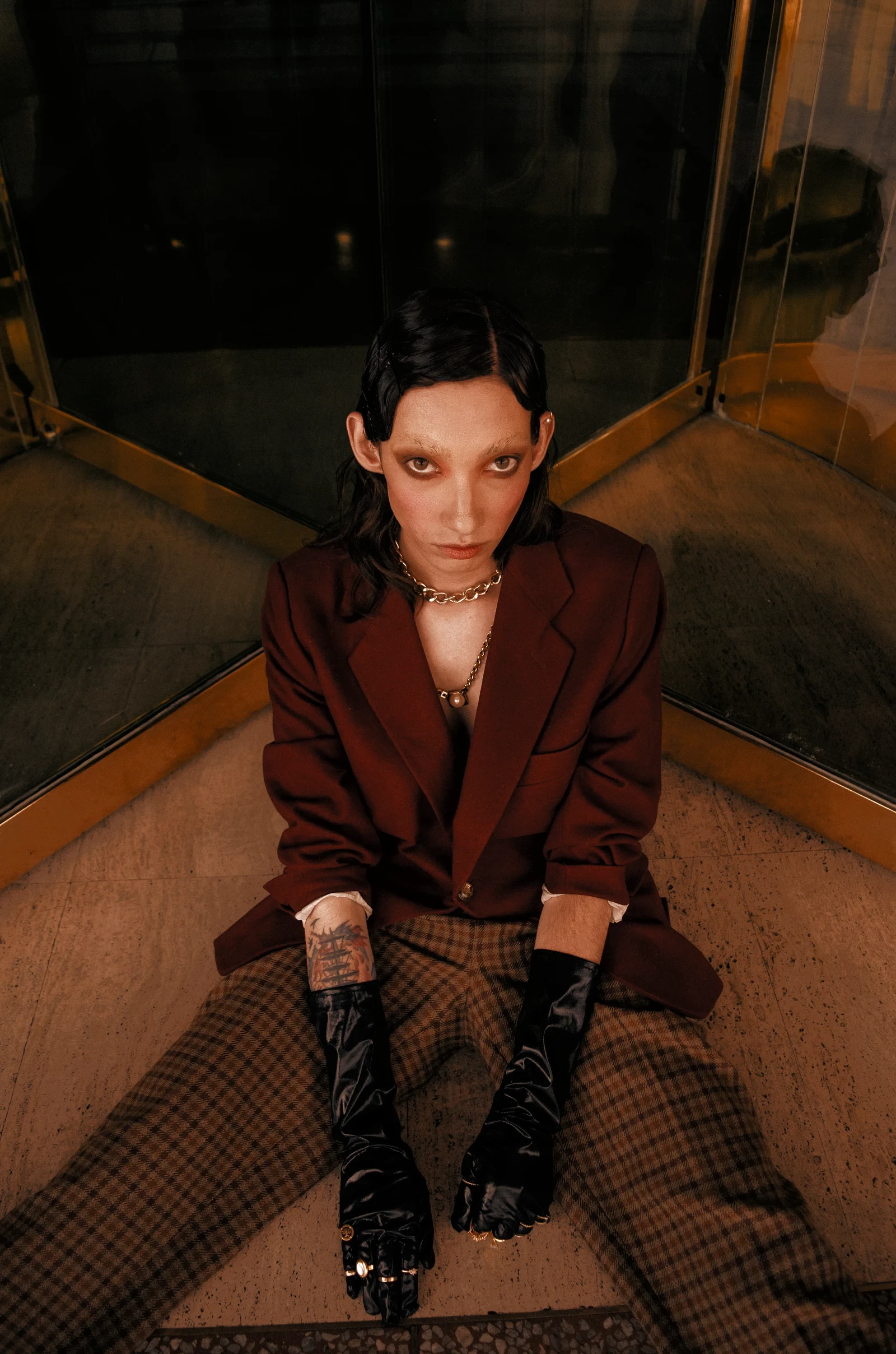 A woman in a red blazer on a stair