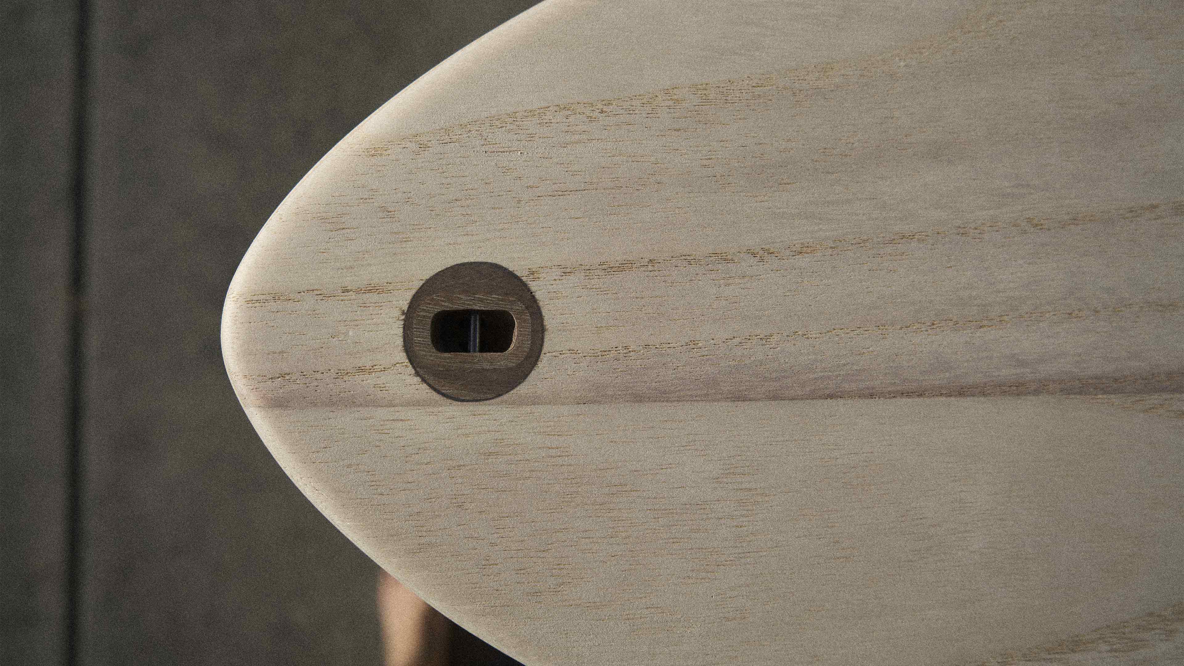 Wooden surfboard tail with wooden leash plug