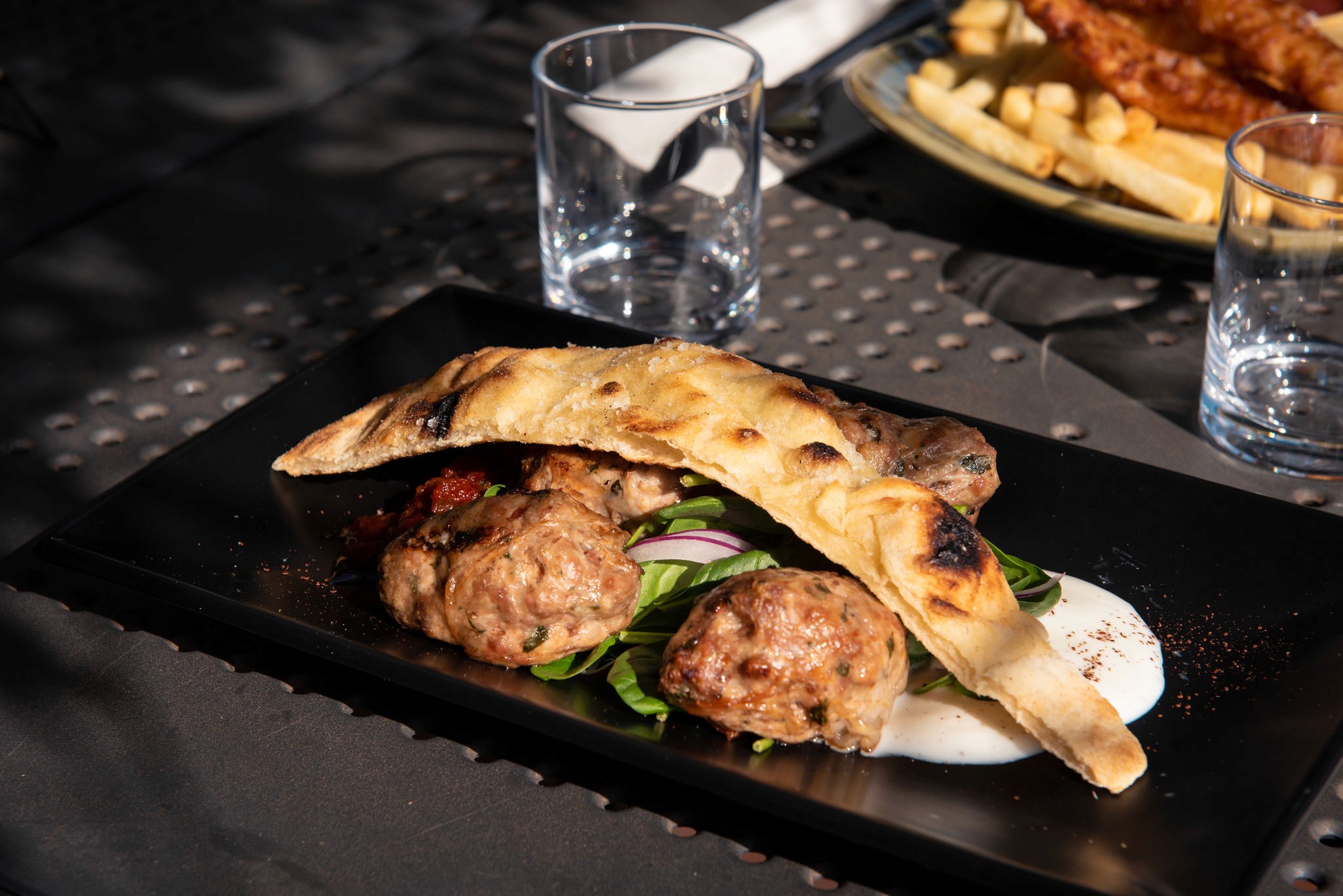 Dark and moody shot of a cocktail sitting on a bar