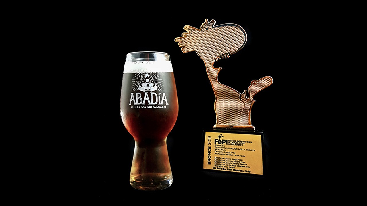 Stacked glass cube with layered translucent liquid on a concrete floor—minimal studio sculpture against a white wall.