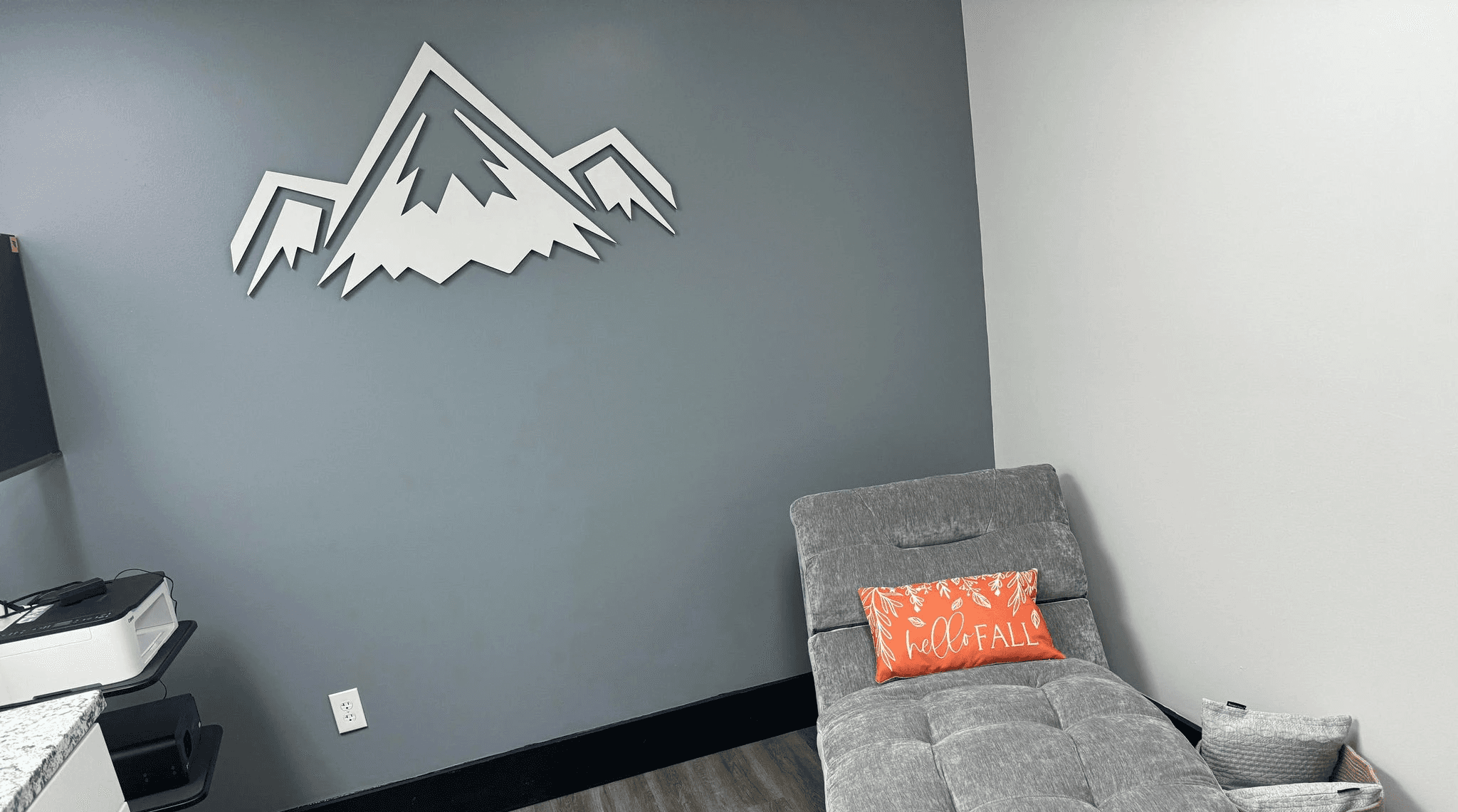 RMR chair with elevate performance labs logo on the wall